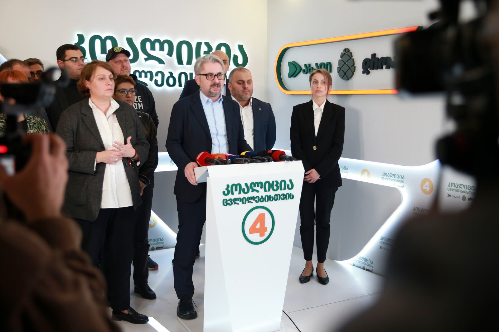 Nika Gvaramia, leader of Coalition for Changes, center, speaks to the media as Elene Khoshtaria, chair of United National Movement, left, and Nana Malashkhia, who leads the Coalition for Change parliament list, right, stand near at coalition's headquarters after the parliamentary election in Tbilisi, Georgia, on Sunday, Oct. 27, 2024. (AP Photo/Zurab Tsertsvadze)