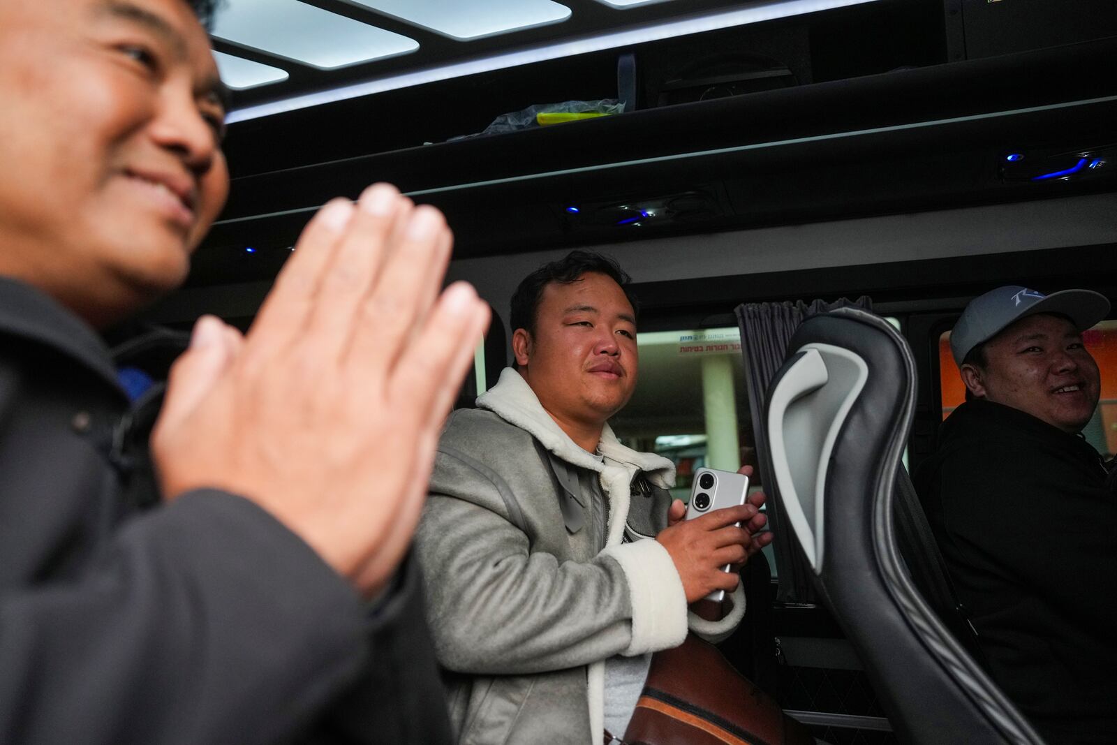 Thai Bannawat Saethao, center, who was released along with another four countrymen from Hamas captivity in Gaza as part of the Israel-Hamas ceasefire deal, leaves Shamir Medical Center (Assaf Harofeh) in Be'er Ya'akov, Israel, Saturday, Feb. 8, 2025. (AP Photo/Ohad Zwigenberg)