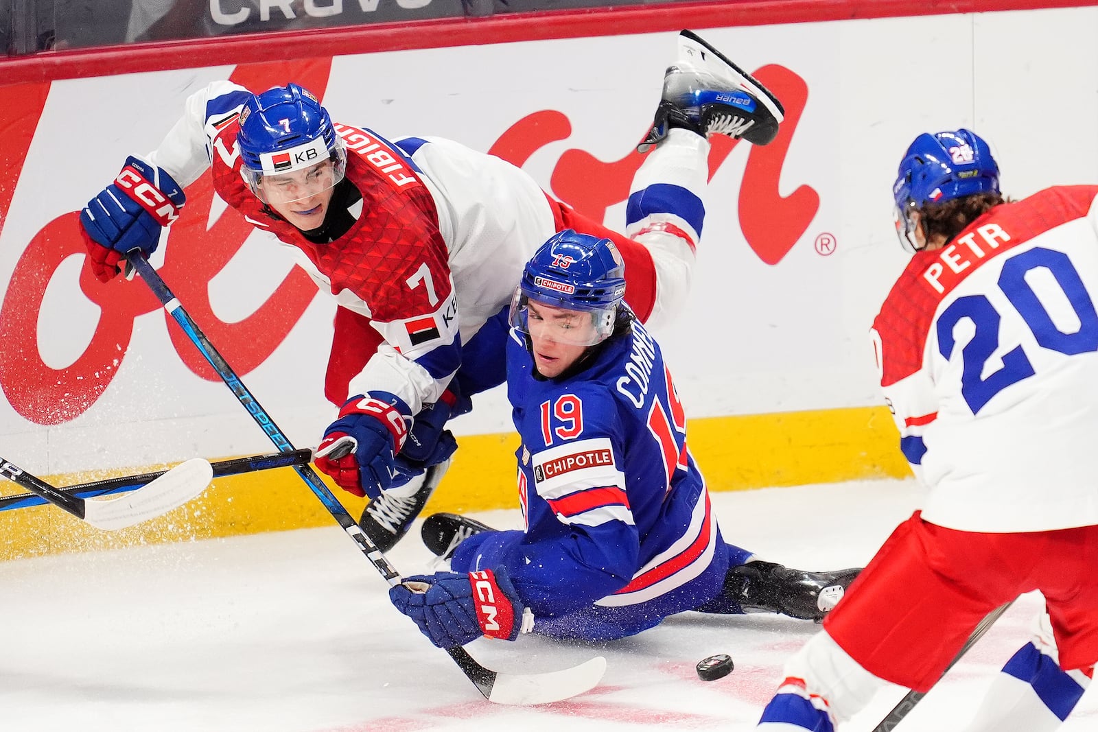 Czechia defenseman Jakub Fibigr (7) is hit by United States forward Trevor Connelly (19) during third-period World Junior hockey championship semifinal game action in Ottawa, Ontario, Saturday, Jan. 4, 2025. (Sean Kilpatrick/The Canadian Press via AP)