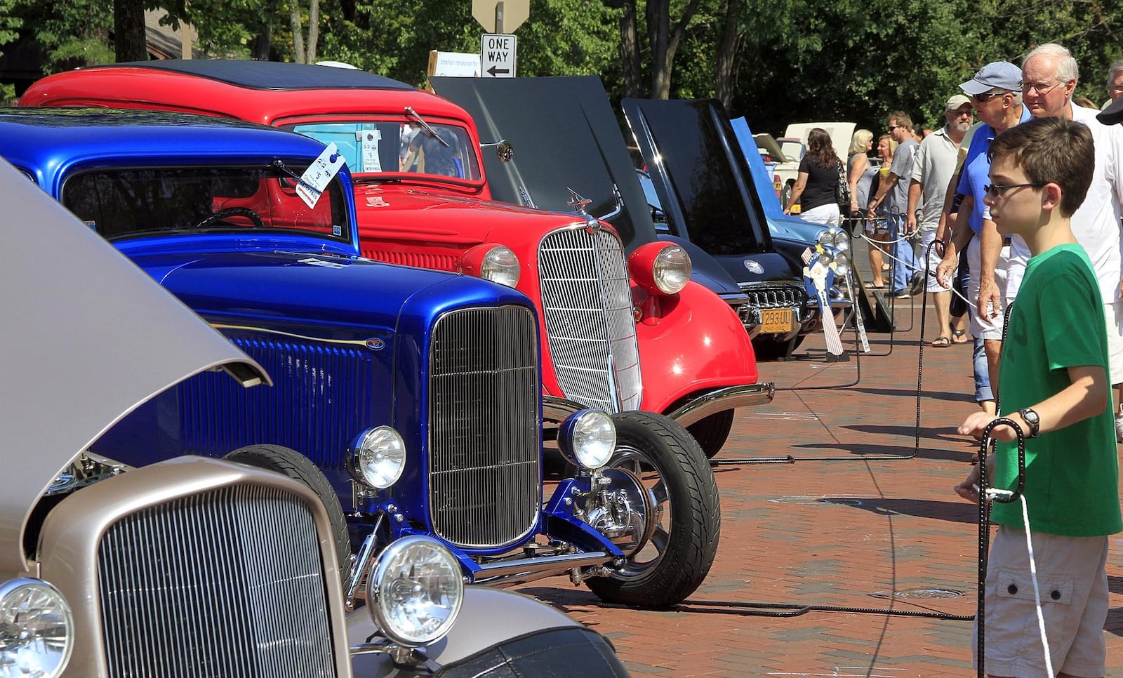 A young man looks over the hot rods at the Kettering Holiday at Home Invitational car show, hekd Sept. 4-5 along Lincoln Park Boulevard. © 2016 Photograph by Skip Peterson