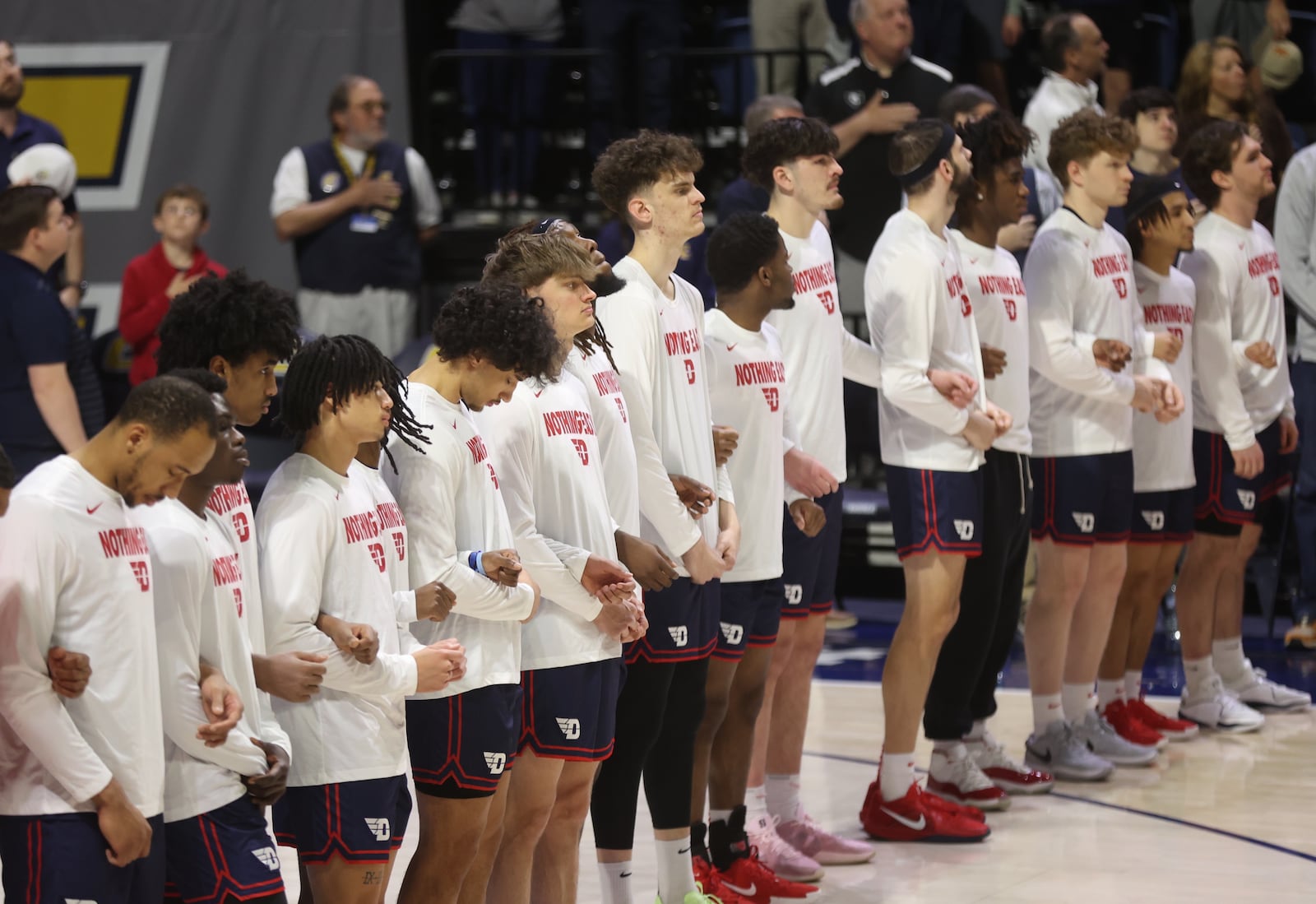 Dayton players stand for the national anthem before a game against Chattanooga in the second round of the National Invitation Tournament on Saturday, March 22, 2025, at McKenzie Arena in Chattanooga, Tenn. David Jablonski/Staff