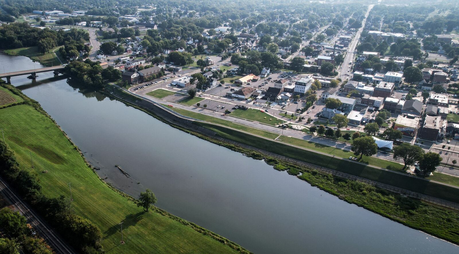 Riverfront Park, in the center on the far side of the Great Miami River,  in Miamisburg is undergoing a redesign which is the final step before a contractor is selected and construction begins. JIM NOELKER/STAFF