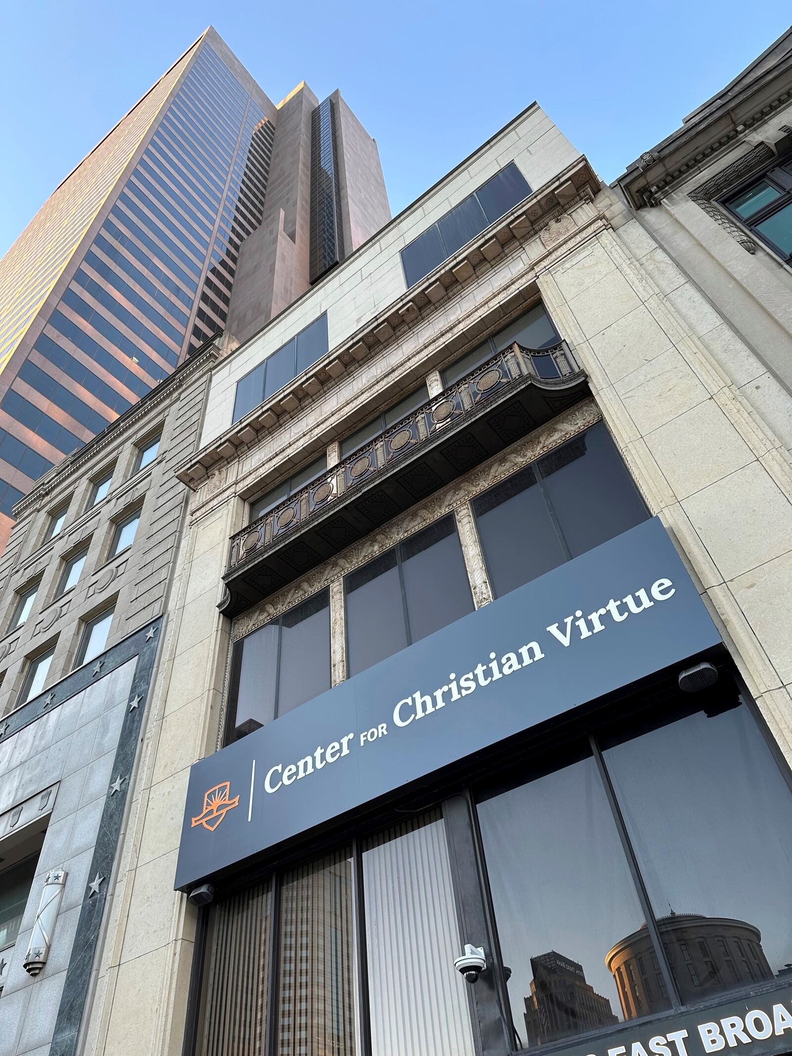 The Center for Christian Virtue sits in the shadow of the Rhodes State Office Tower in downtown Columbus, Ohio, on Monday, Nov. 11, 2024. The Ohio Statehouse, which sits across the street, is reflected in the building's facade. (AP Photo/Julie Carr Smyth)