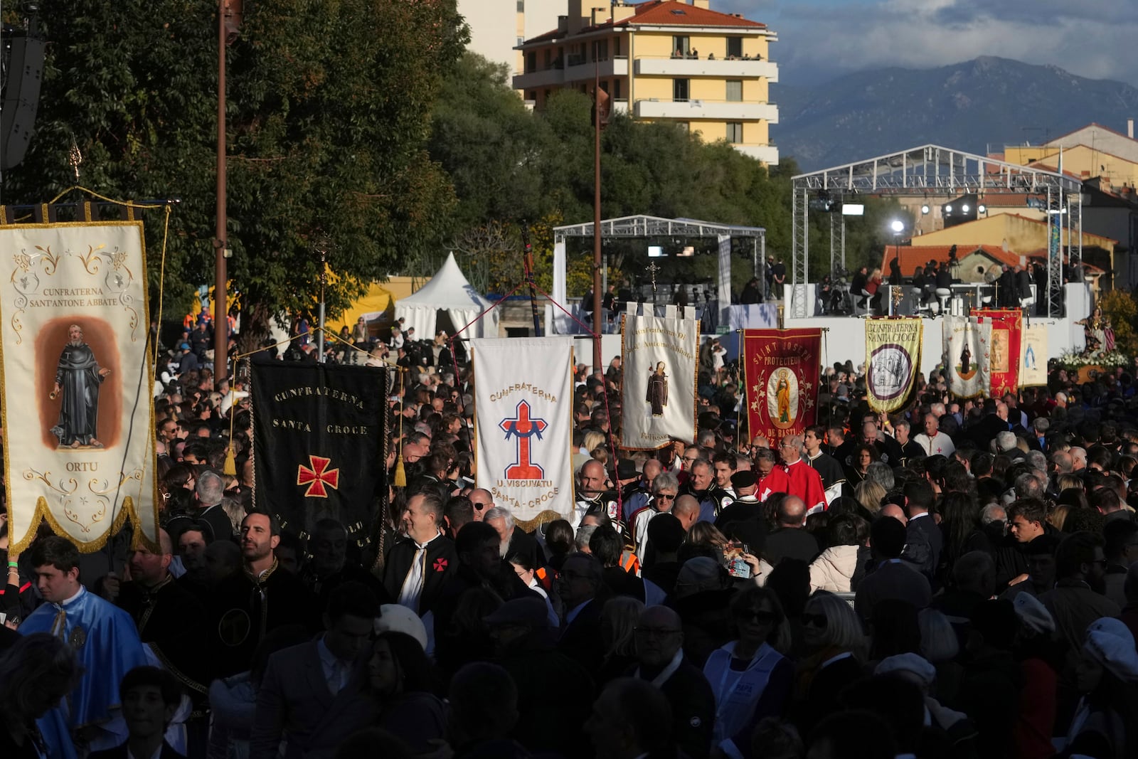 Members of catholic local brotherhoods arrive for a mass Sunday, Dec. 15, 2024 in Ajaccio, Corsica island, as Pope Francis' one-day visit to Corsica puts a dual focus on the Mediterranean, highlighting local traditions of popular piety on the one hand and migrant deaths and wars on the other. (AP Photo/Thibault Camus)