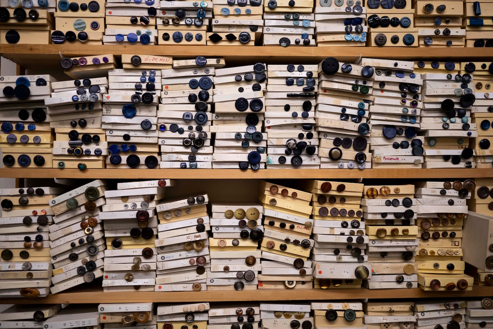 Paper boxes are full of buttons in the workshop of Lambert Hofer, a renowned costume workshop in Vienna, Austria, Wednesday, Febr 26, 2025. (AP Photo/Denes Erdos)