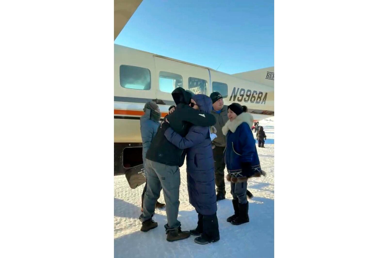 In this screen grab from a Facebook livestream, a Bering Air pilot is hugged by a resident of the Inupiat Eskimo village of Golovin in Alaska on Saturday, Feb. 8, 2025 (AP via Irene Navarro)