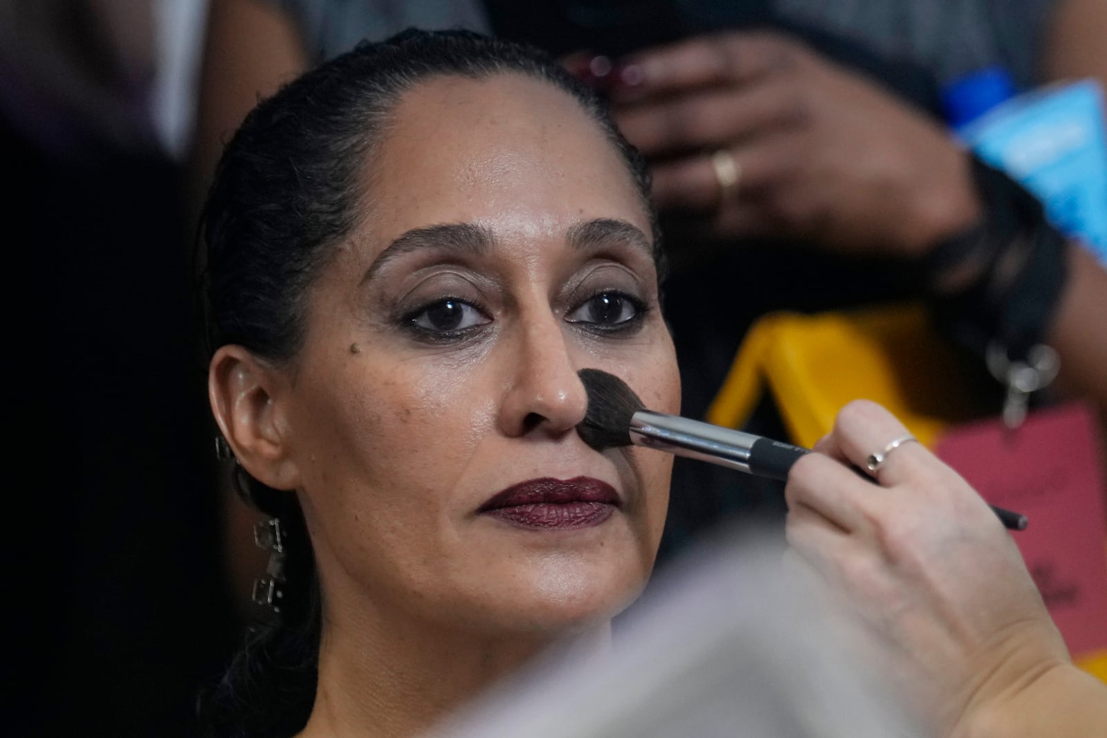 Actress Tracee Ellis Rossgets is made up by a make up artist in the backstage prior a Marni Fall/Winter 2025-2026 Womenswear fashion show, during the Fashion Week, in Milan, Italy, Wednesday, Feb. 26, 2025. (AP Photo/Luca Bruno)