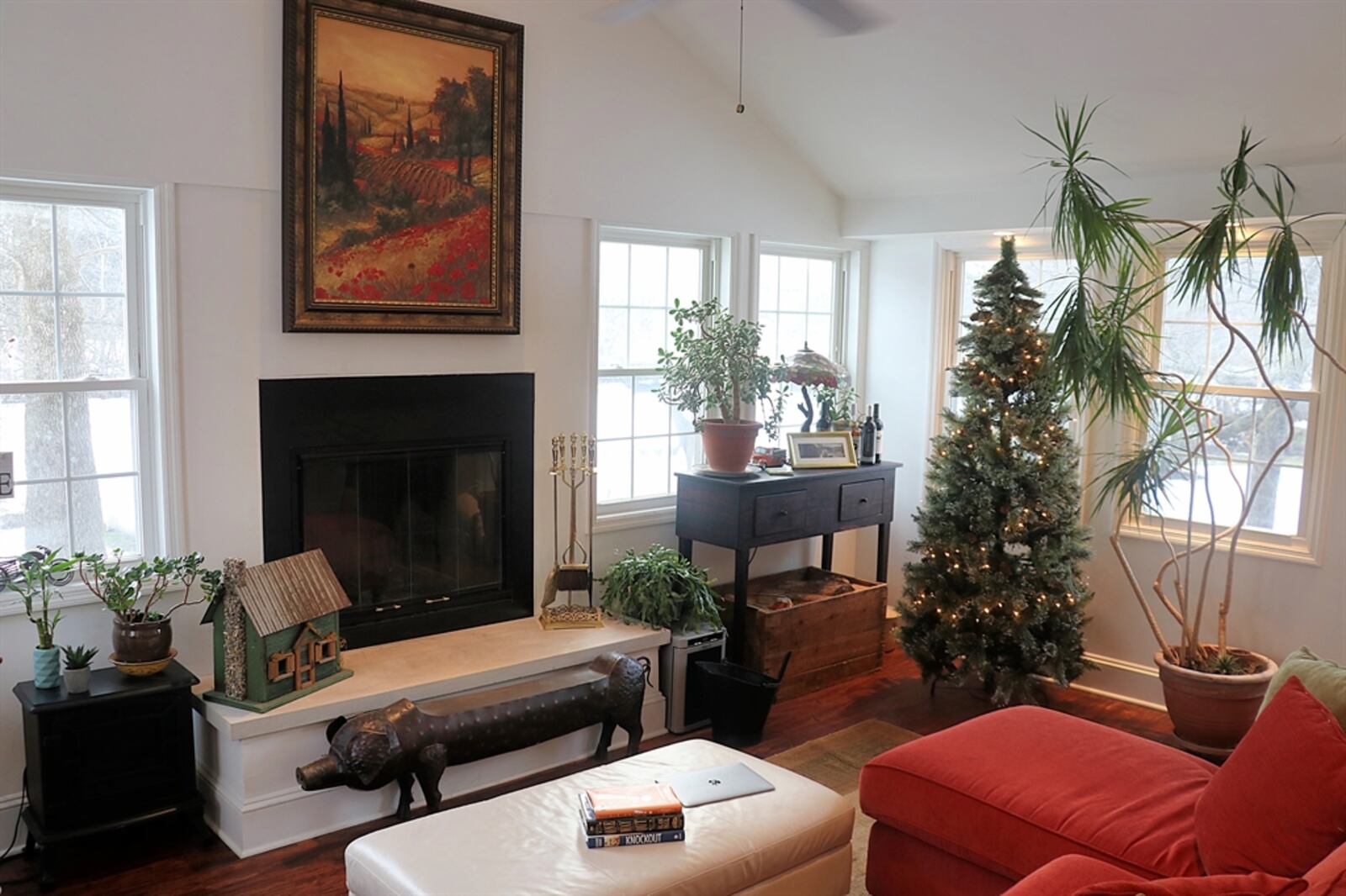 Off the living room is a family room, which has a cathedral ceiling and walls of windows. The wood-burning fireplace has a raised hearth with marble cap.