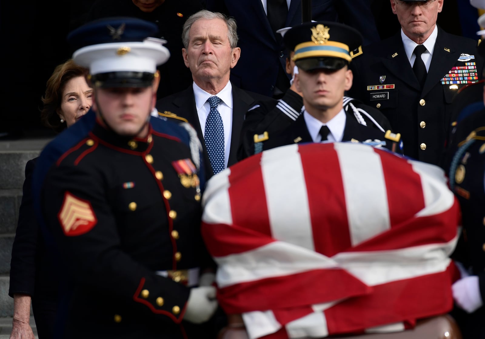 FILE - Former President George W. Bush and former first lady Laura Bush, left, follow the casket of former President George H.W. Bush, carried out following a State Funeral at the National Cathedral in Washington, Dec. 5, 2018. (AP Photo/Susan Walsh, File)