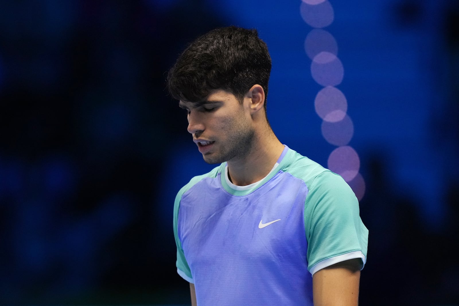 Spain's Carlos Alcaraz reacts during the singles tennis match of the ATP World Tour Finals agains Denmark's Casper Ruud, at the Inalpi Arena, in Turin, Italy, Monday, Nov. 11, 2024. (AP Photo/Antonio Calanni)