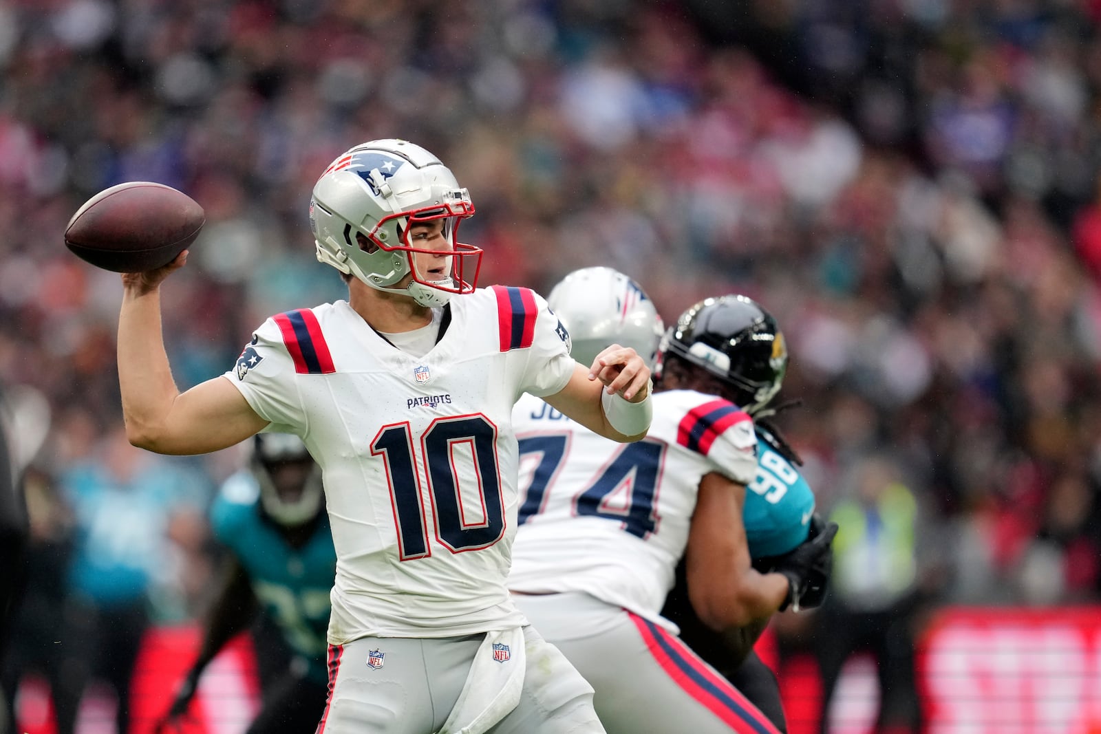 New England Patriots quarterback Drake Maye (10) throws during the first half of an NFL football game against the Jacksonville Jaguars, Sunday, Oct. 20, 2024, in London. (AP Photo/Kin Cheung)