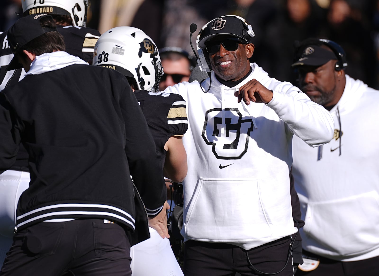 Colorado head coach Deion Sanders, right, congratulates place kicker Cristiano Palazzo after he kicked an extra point in the second half of an NCAA college football game against Oklahoma State, Friday, Nov. 29, 2024, in Boulder, Colo. (AP Photo/David Zalubowski)