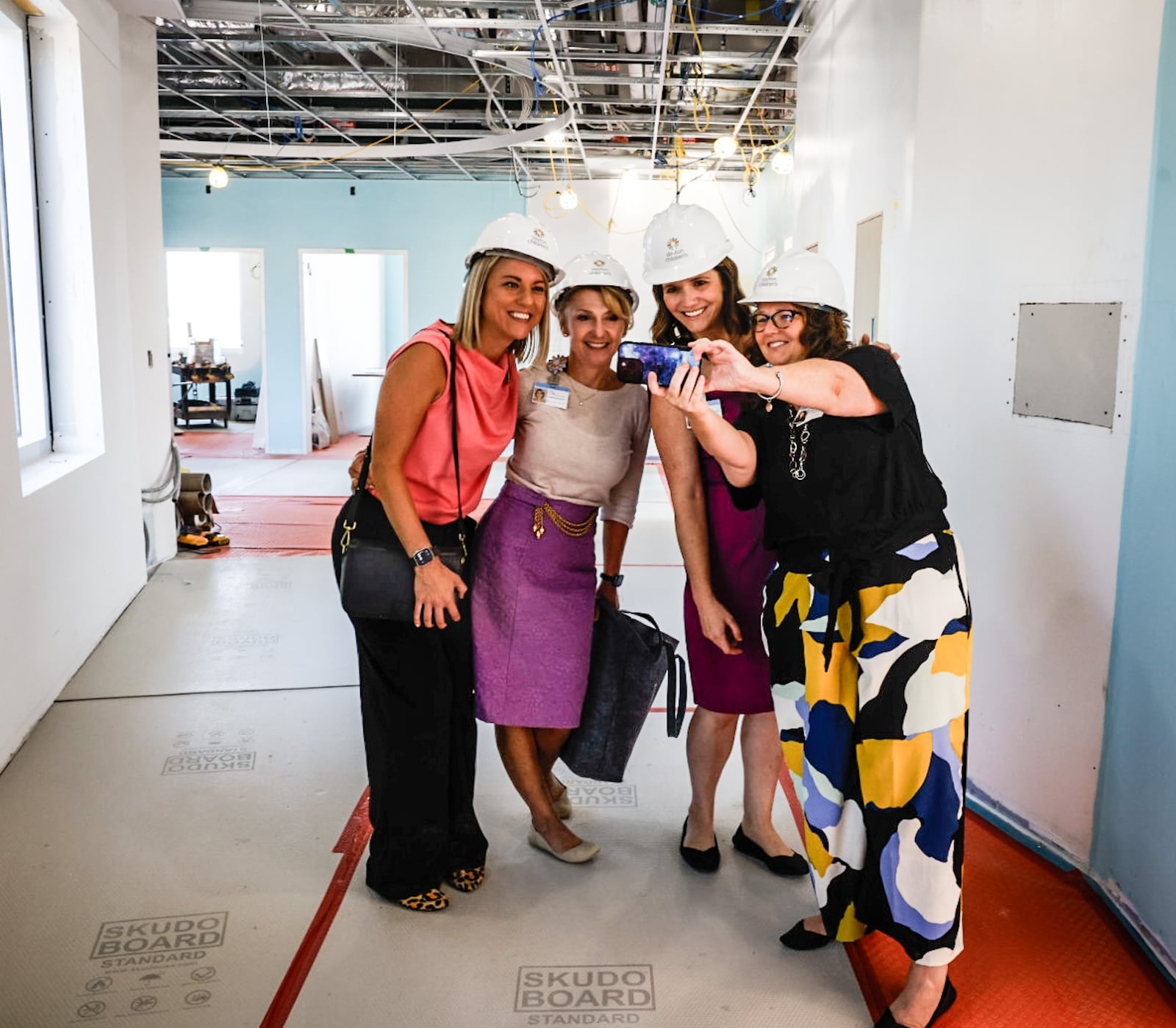 Dayton Children's Hospital marketing department employees pose for a selfie in the under construction Dayton Children's Hospital Mental Health Building. JIM NOELKER/STAFF