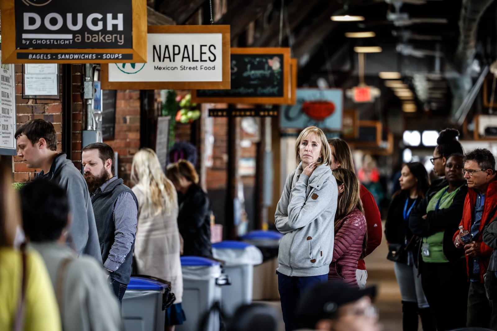 Sarah Romaker, from Cincinnati, waits in line for lunch at the 2nd Street Market Friday April 29, 2022. The lunchtime crowds along with the weekend shoppers are back after two years of COVID restrictions. JIM NOELKER/STAFF