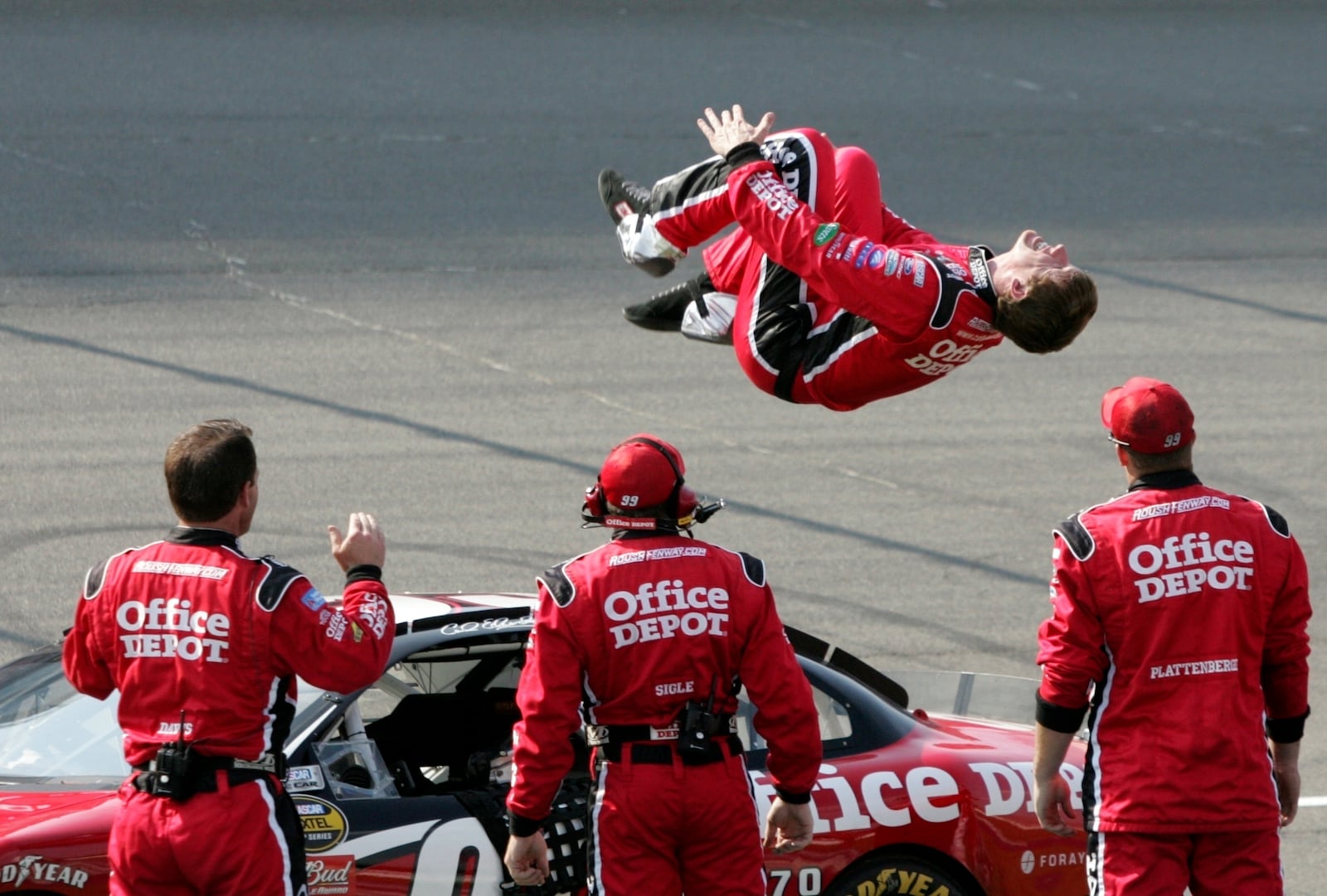 FILE - Carl Edwards does a backflip at the finish line after winning the NASCAR Cup Series auto race at Michigan International Speedway in Brooklyn, Mich., June 17, 2007. (AP Photo/Bob Brodbeck, File)