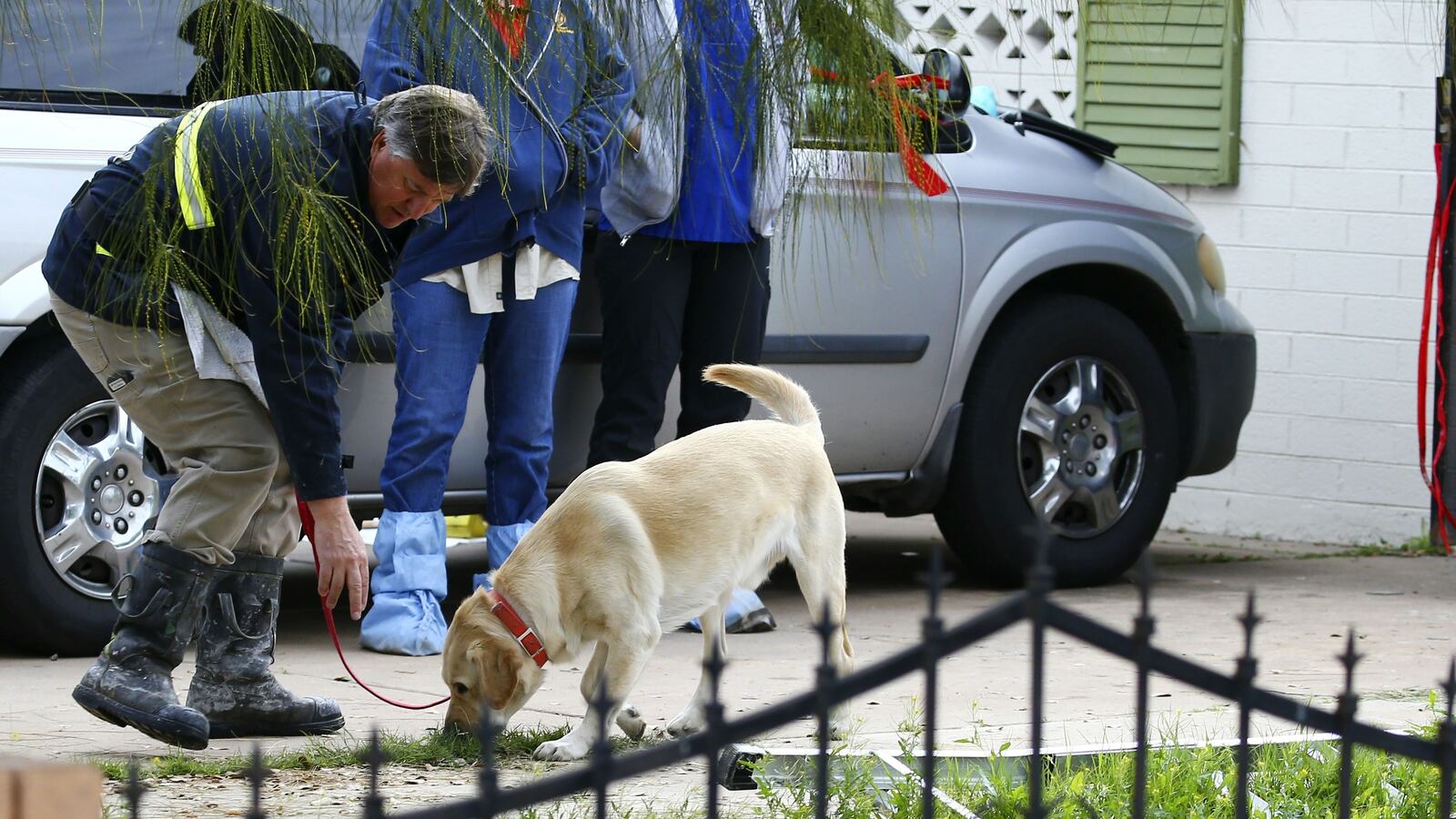 A Phoenix Fire Department canine investigator works Wednesday, Jan. 29, 2020, outside the home of Rafael and Maribel Loera. The couple are charged with concealing their dead 11-year-old daughter’s body in their attic for more than two years and abusing their surviving children.