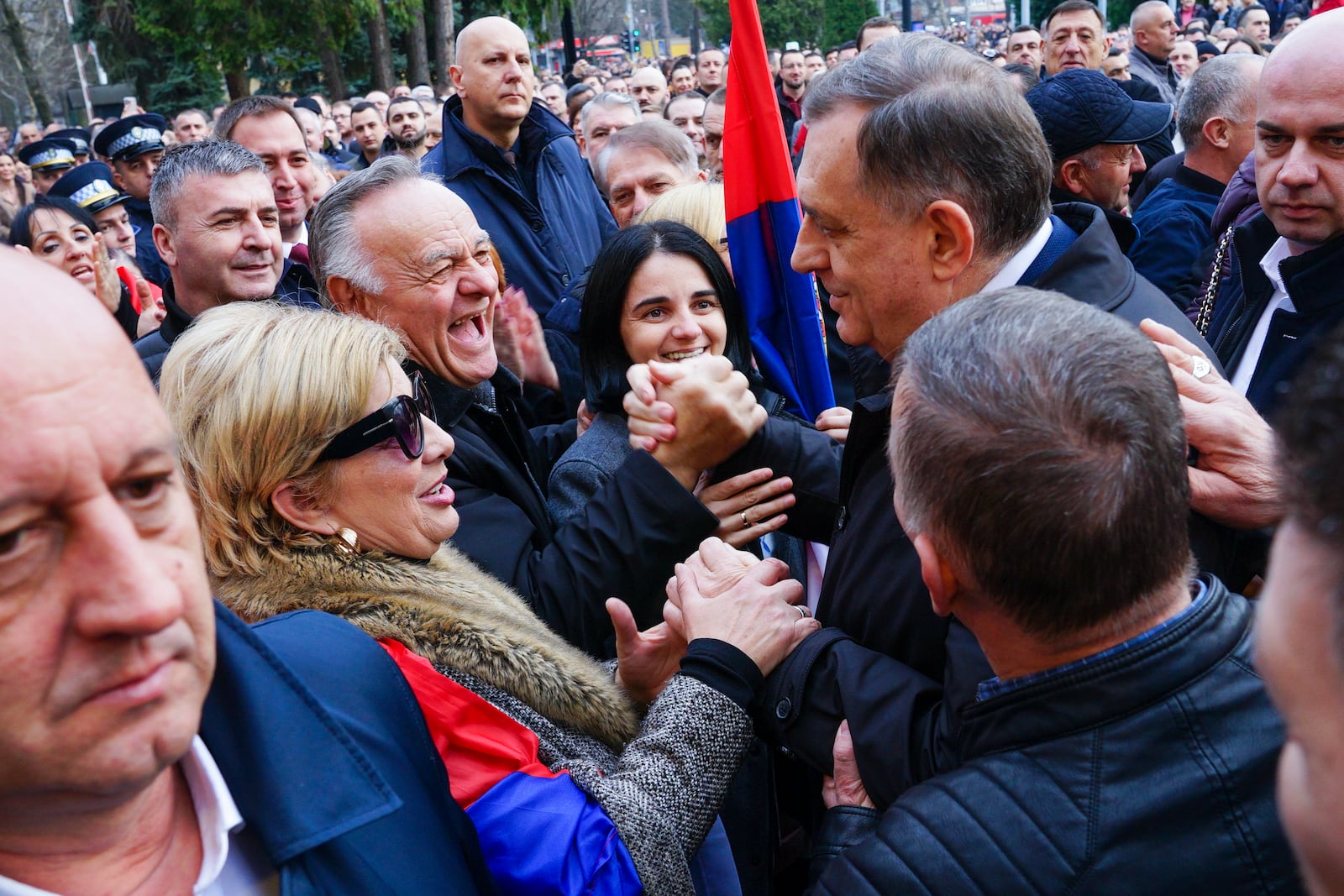 Bosnian Serb President Milorad Dodik, right, shakes hands with supporters rallied as tensions soared on the eve of a scheduled court verdict that could order the pro-Russia Serb leader banned from politics or even sentenced to prison in the Bosnian town of Banja Luka, 240 kms northwest of Sarajevo, Tuesday, Feb. 25, 2025. (AP Photo/Radivoje Pavicic)