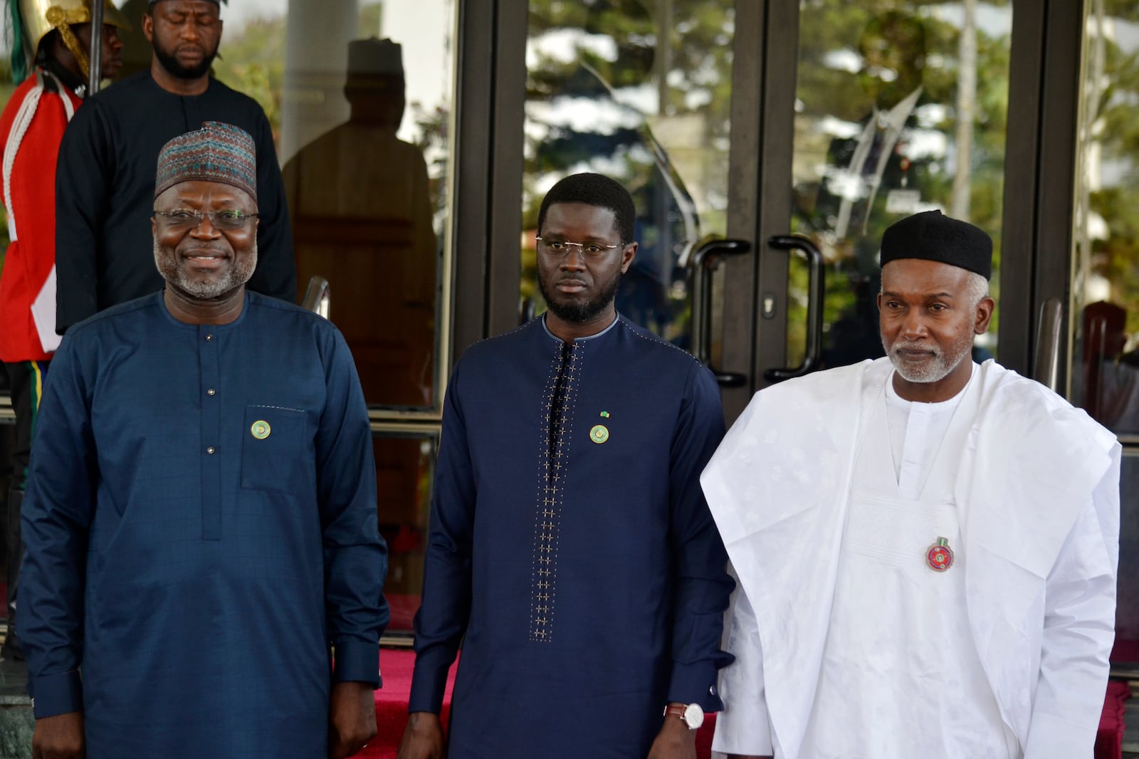 Omar Touray, president of the ECOWAS Commission, left, Senegal's President Basirou Diomaye Faye, center and Nigeria Minister of Foreign Affairs, Yusuf Tuggar pose for a photo, prior to the start of the ECOWAS meeting in Abuja, Nigeria, Sunday, Dec 15, 2024. (AP Photo/Olamikan Gbemiga)