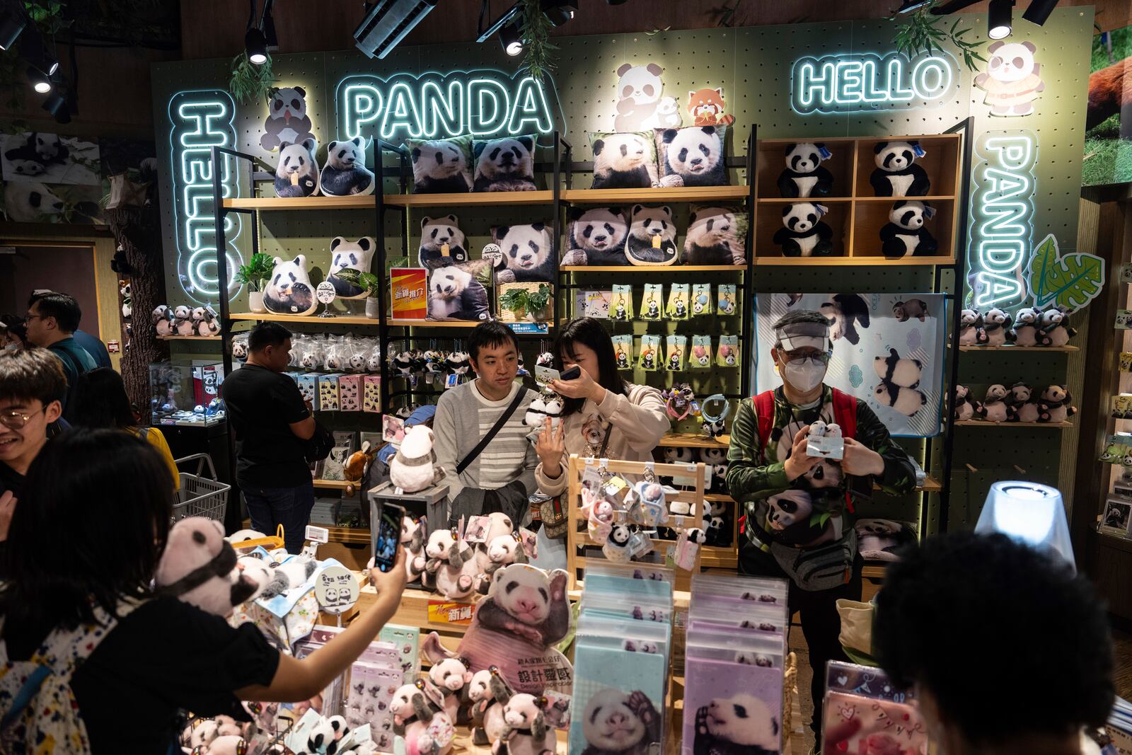 Visitors shop at a panda-themed store in Ocean Park as the Hong Kong-born giant panda twin cubs make their debut appearance to public in Hong Kong, Sunday, Feb. 16, 2025. (AP Photo/Chan Long Hei)