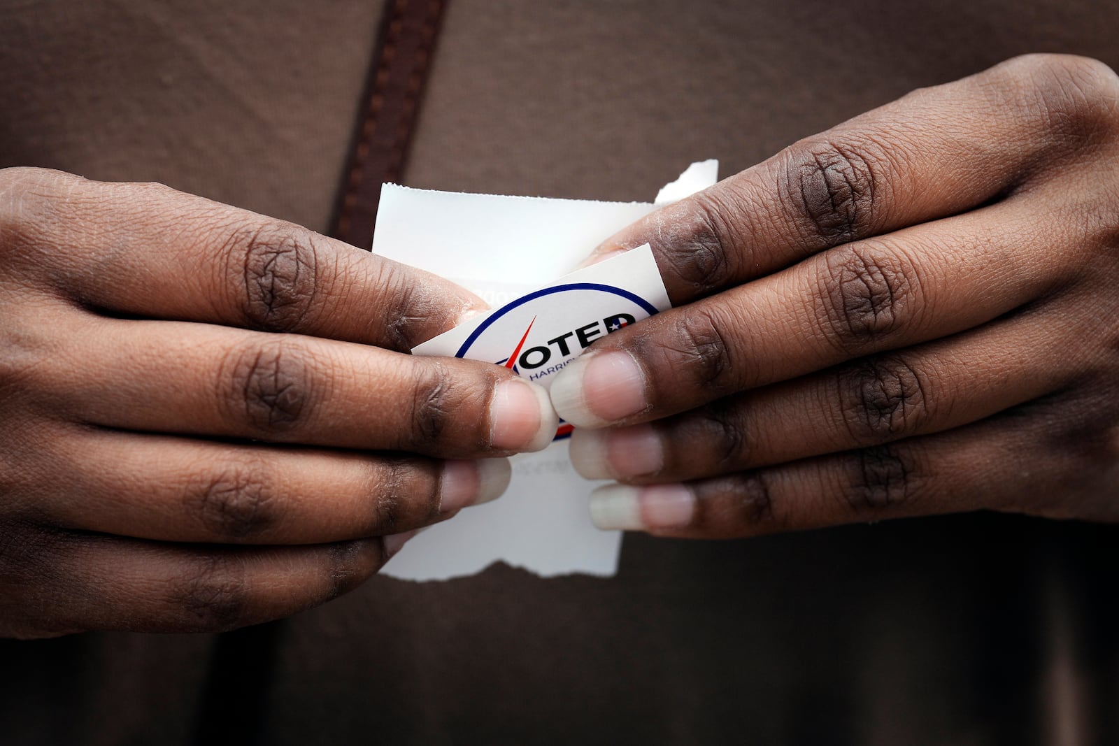 A voter holds a "I Voted" sticker after casting their vote for General Election on Election Day Tuesday, Nov. 5, 2024 at Sunnyside Health and Multi-Service Center in Houston. (Yi-Chin Lee/Houston Chronicle via AP)