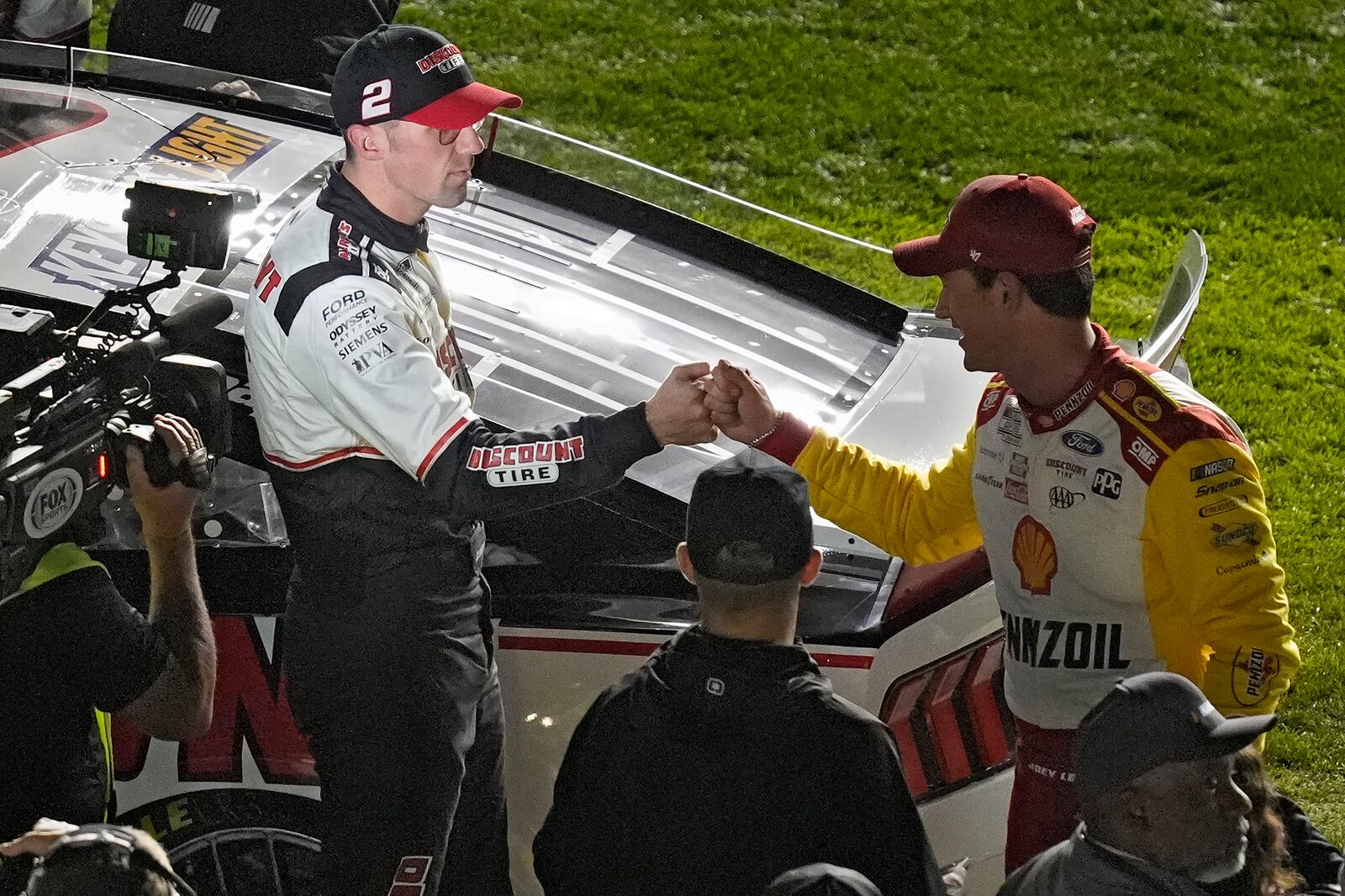 Austin Cindric (2) celebrates with Joey Logano after winning during the second of two NASCAR Daytona 500 qualifying auto races Thursday, Feb. 13, 2025, at Daytona International Speedway in Daytona Beach, Fla. (AP Photo/Chris O'Meara)