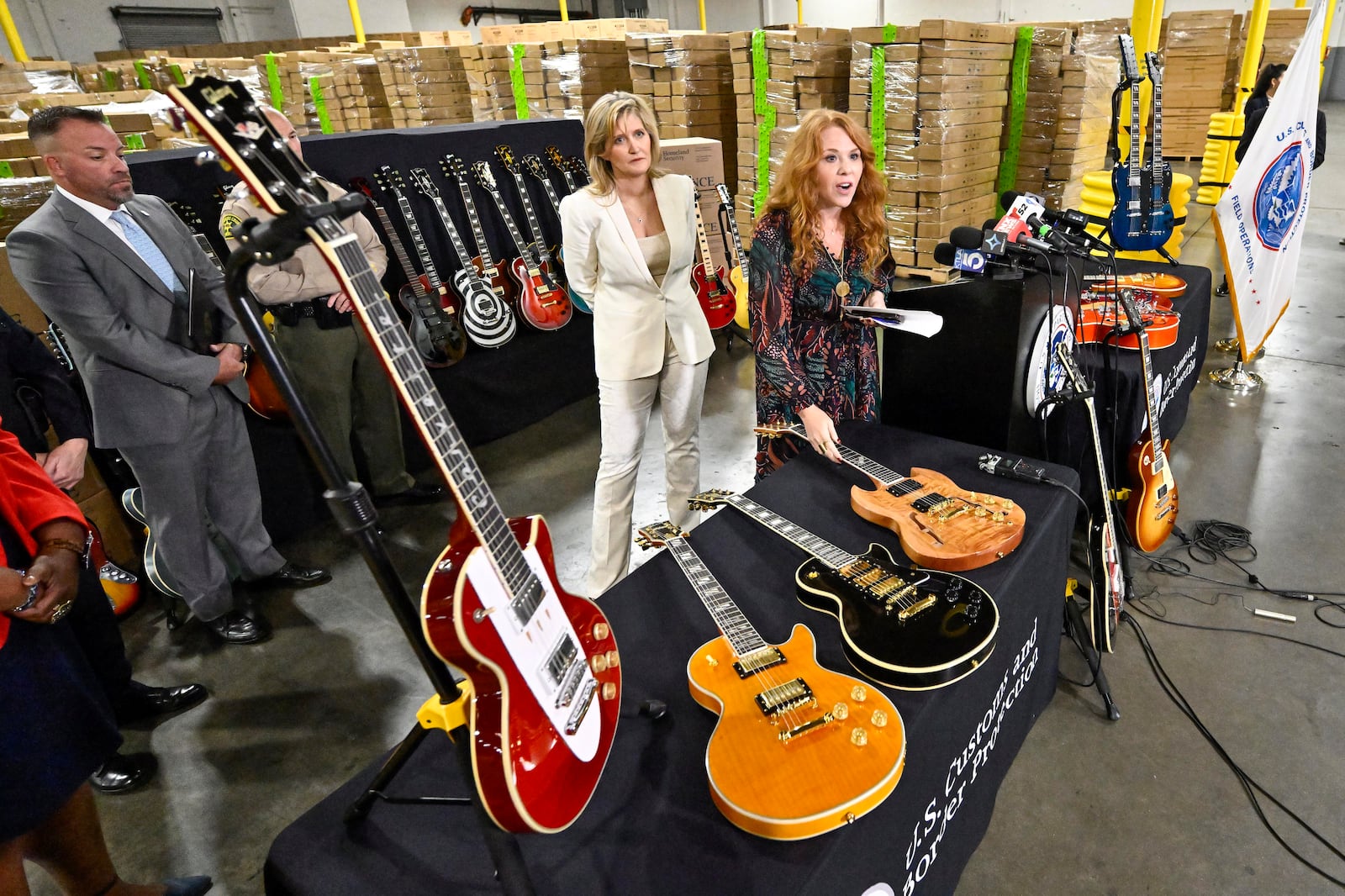 Andrea Bates, attorney for Gibson, left, and Elizabeth "Beth" Heidt, chief marketing officer, Gibson Inc., answer questions during a U.S. Customs and Border Protection press conference after more than 3000 counterfeit Gibson guitars were seized, in Carson, Calif., on Tuesday, Nov. 26, 2024. (Jeff Gritchen/The Orange County Register via AP)