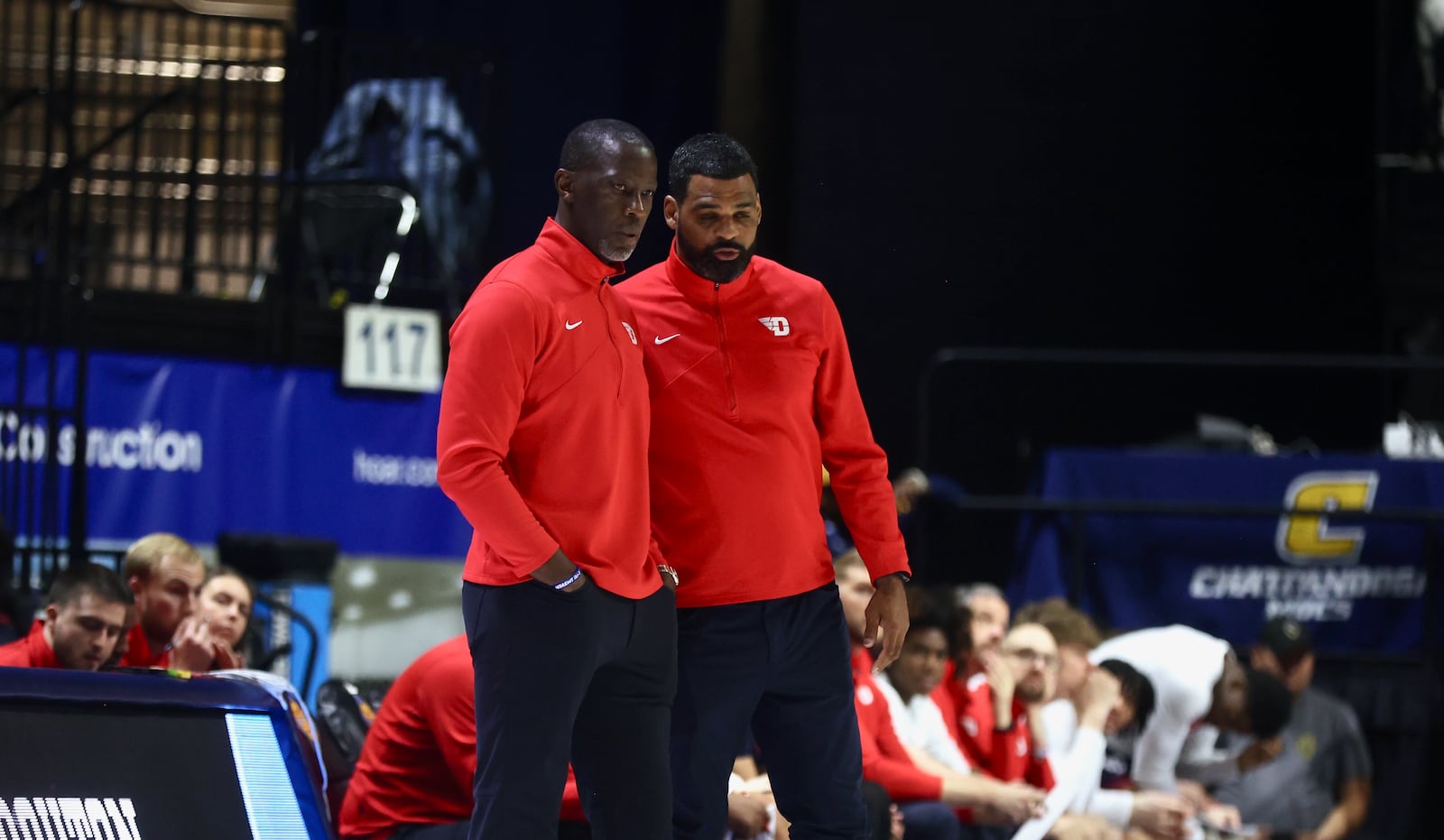 Dayton's Anthony Grant and Ricardo Greer talk during a game against Chattanooga in the second round of the National Invitation Tournament on Saturday, March 22, 2025, at McKenzie Arena in Chattanooga, Tenn. David Jablonski/Staff