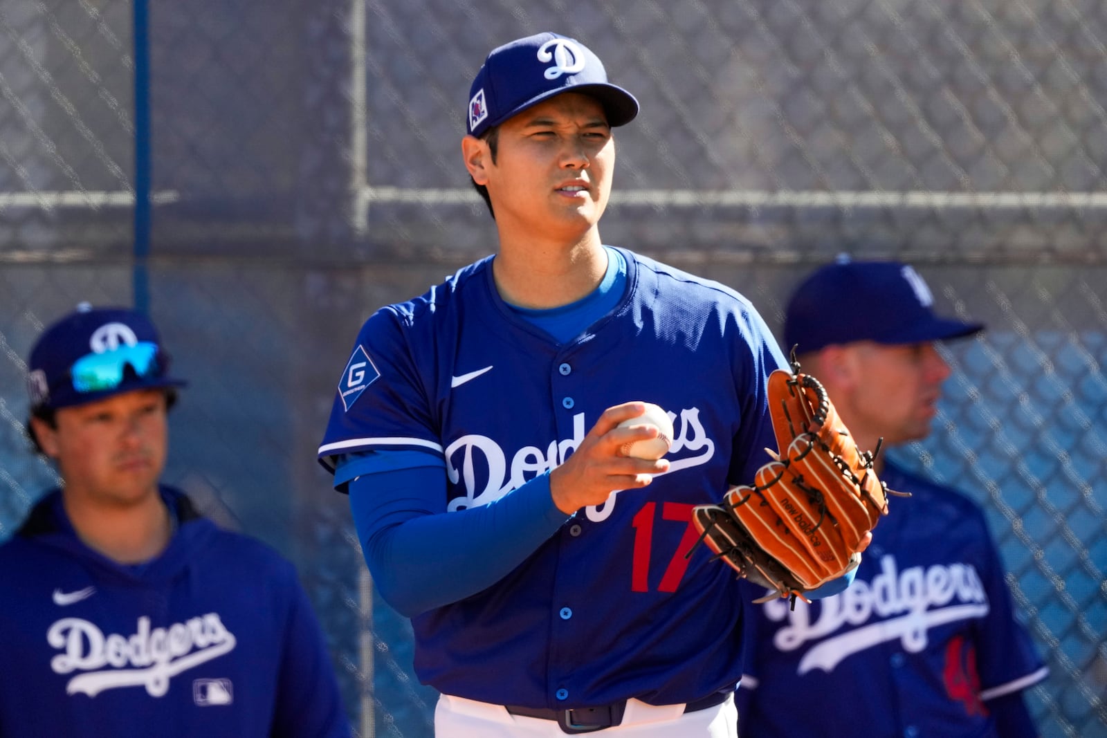 Los Angeles Dodgers two-way player Shohei Ohtani (17) works out during spring training baseball practice, Saturday, Feb. 15, 2025, in Phoenix. (AP Photo/Ashley Landis)