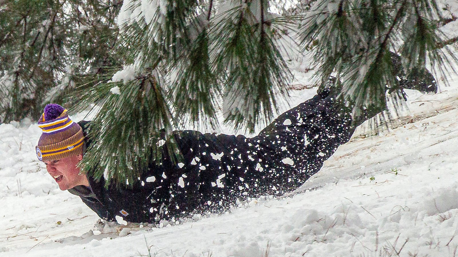 Drew McDonald slides down a hill as snow falls Friday, Jan. 10, 2025, in East Florence, Ala. (Dan Busey/The TimesDaily via AP)