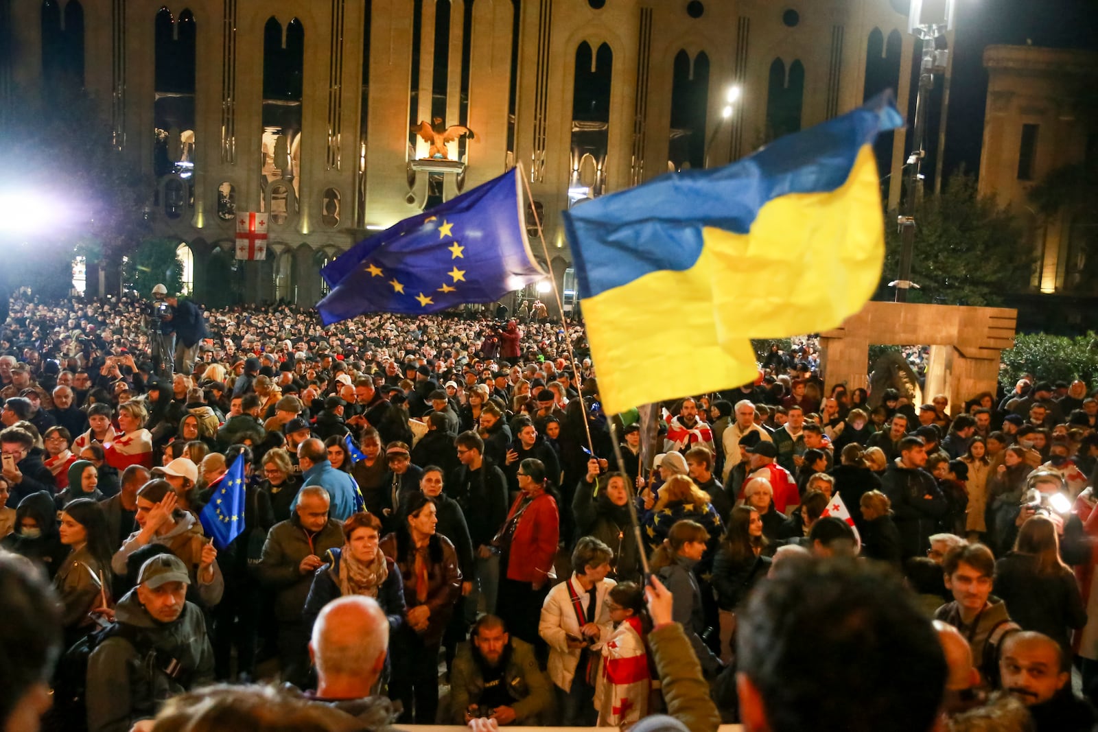 Demonstrators wave EU and Ukrainian national flags as they gather during an opposition protest against the results of the parliamentary election in Tbilisi, Georgia, Monday, Oct. 28, 2024. (AP Photo/Zurab Tsertsvadze)