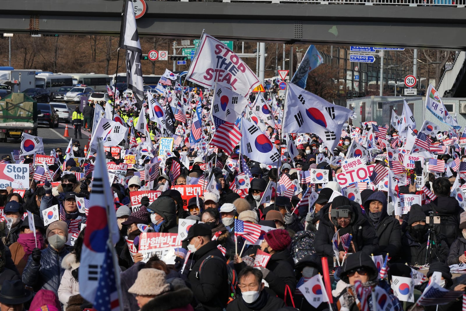 FILE - Supporters of impeached South Korean President Yoon Suk Yeol stage a rally to oppose a court having issued a warrant to detain Yoon, near the presidential residence in Seoul, South Korea, Jan. 3, 2025. The letters read, "Oppose Impeachment." (AP Photo/Lee Jin-man, File)