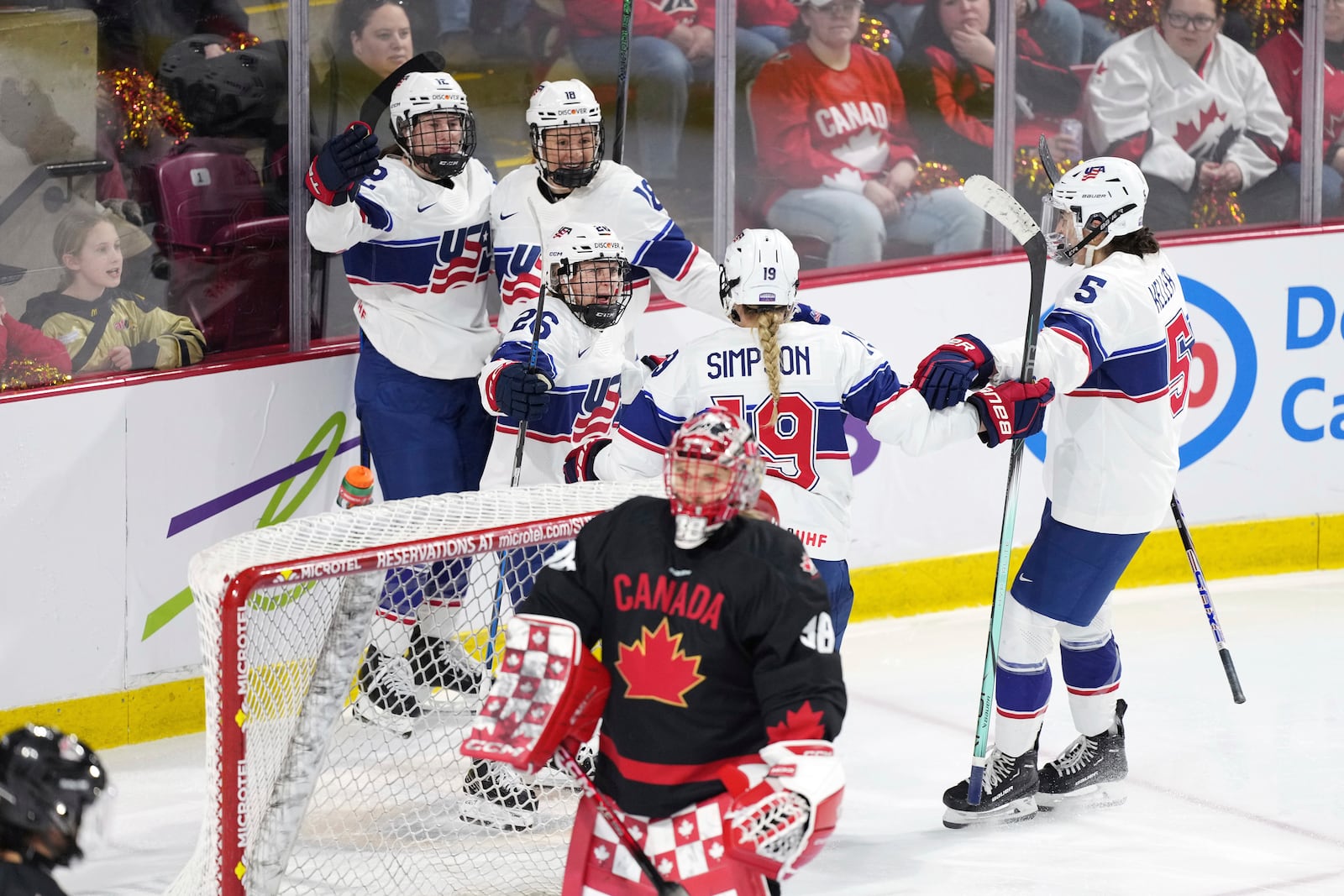 Members of Team USA celebrate a goal behind Team Canada goaltender Emerance Maschmeyer during the third period of Rivalry Series hockey action in Summerside, Canada, on Saturday, Feb. 8, 2025. (Darren Calabrese/The Canadian Press via AP)