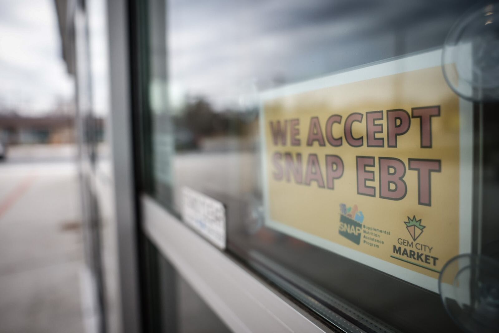 A small sign at the entrance of Gem City Market on Salem Avenue tells customers the store accepts Supplemental Nutrition Assistance Program (SNAP) cards. JIM NOELKER/STAFF