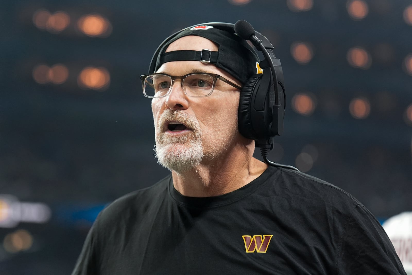 Washington Commanders head coach Dan Quinn watches against the Detroit Lions during the first half of an NFL football divisional playoff game, Saturday, Jan. 18, 2025, in Detroit. (AP Photo/Seth Wenig)