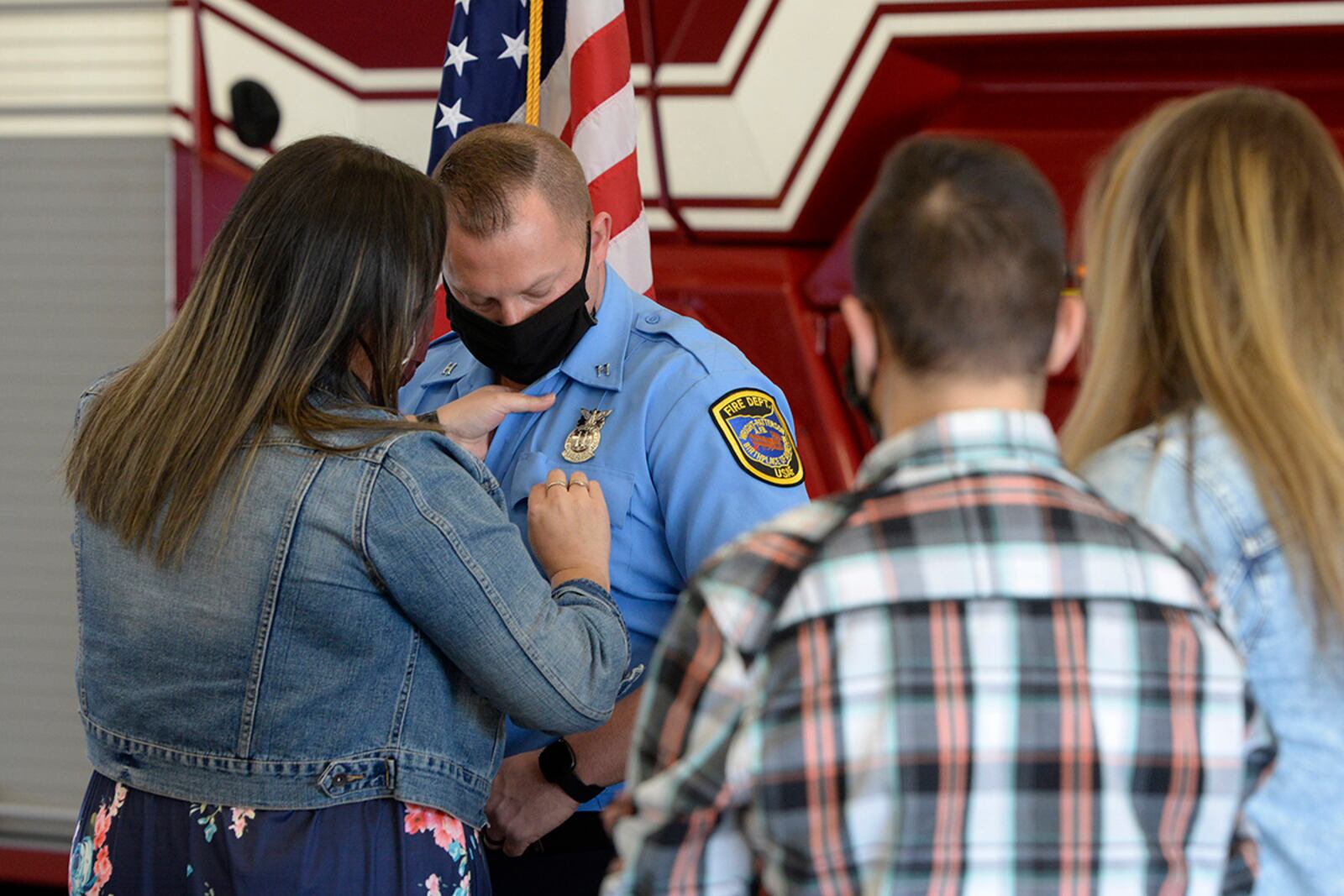 Capt. James Hammond, an Air Force firefighter with the 788th Civil Engineer Squadron, is pinned on by his wife, Ashlee, and children J.J. and Madison during a promotion ceremony at Wright-Patterson Air Force Base on March 29. U.S. AIR FORCE PHOTO/TY GREENLEES