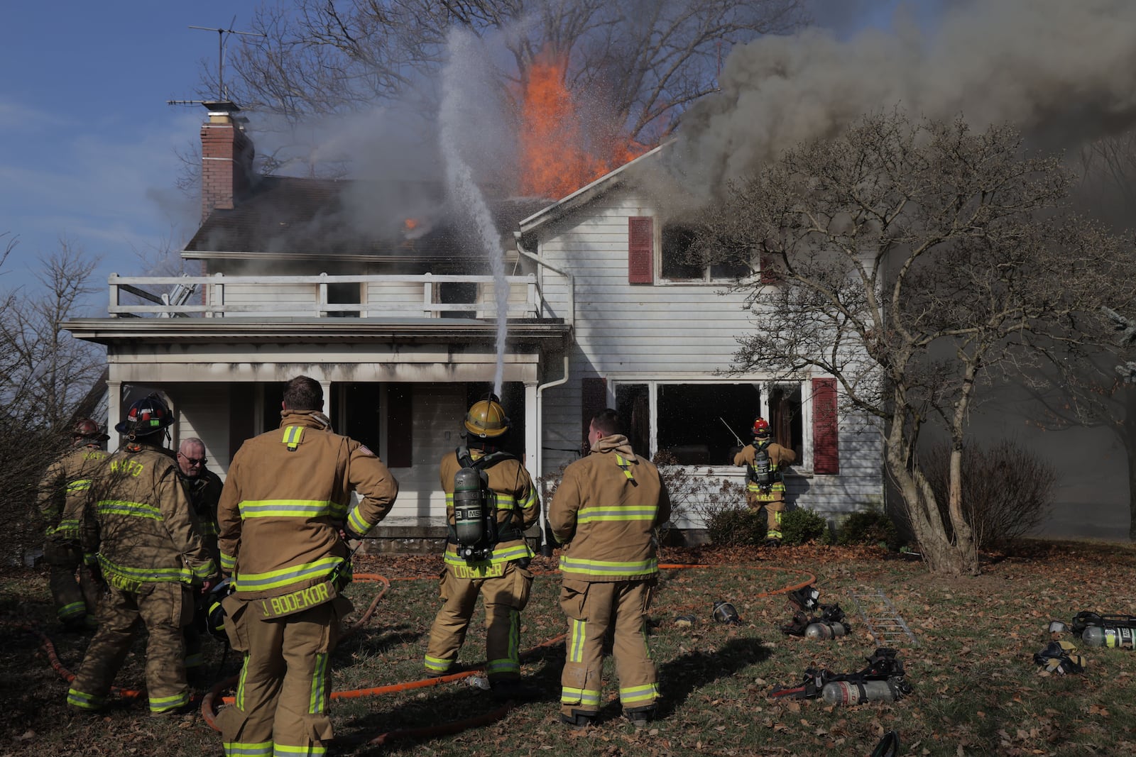 Heavy smoke and flames were reported at a house on Milton Carlisle Road in New Carlisle on Friday, March 14, 2025. BILL LACKEY/STAFF