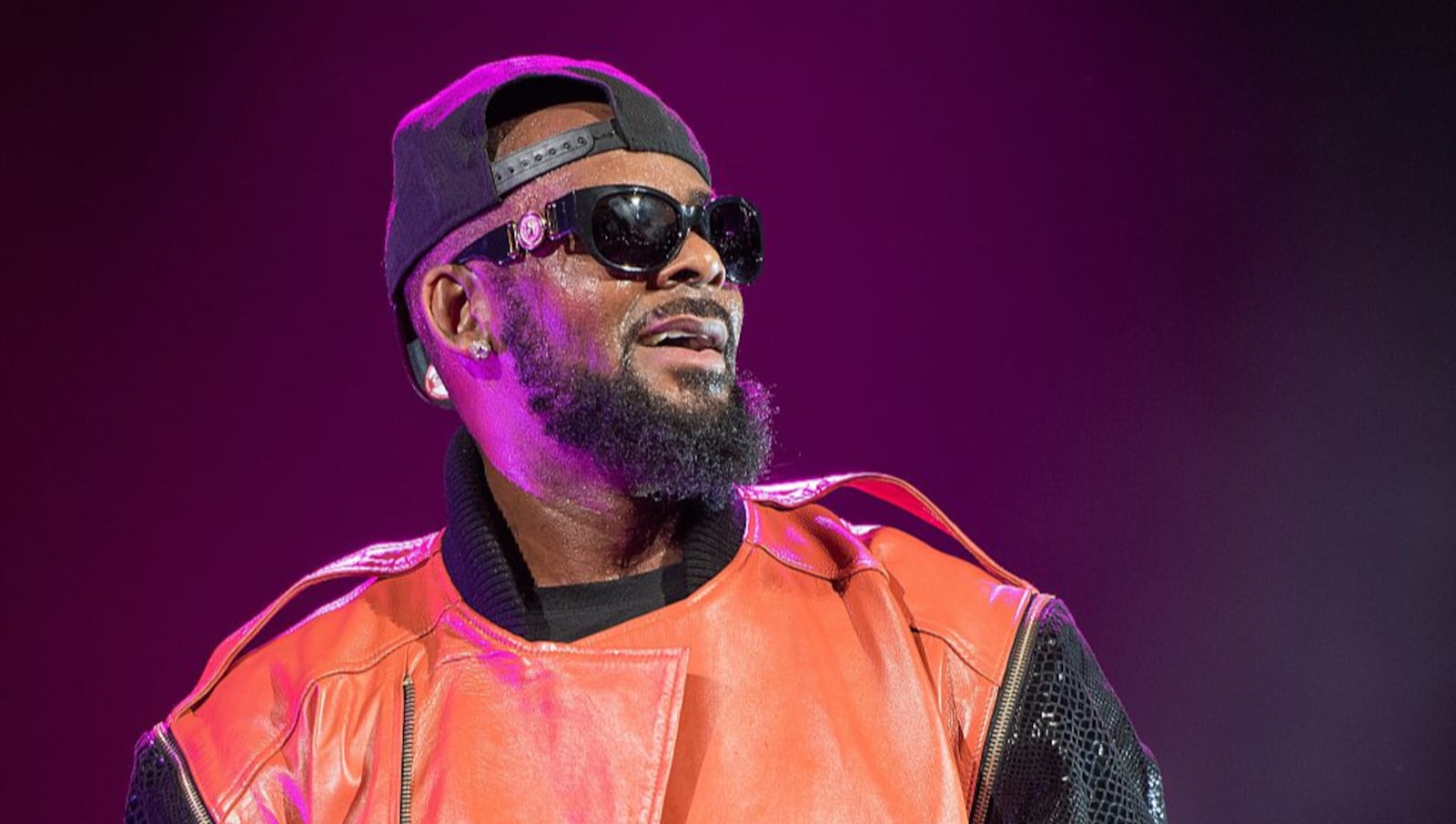 An alleged victim in musician R. Kelly's "cult," says she is fine, despite BuzzFeed's report on the singer's behavior.