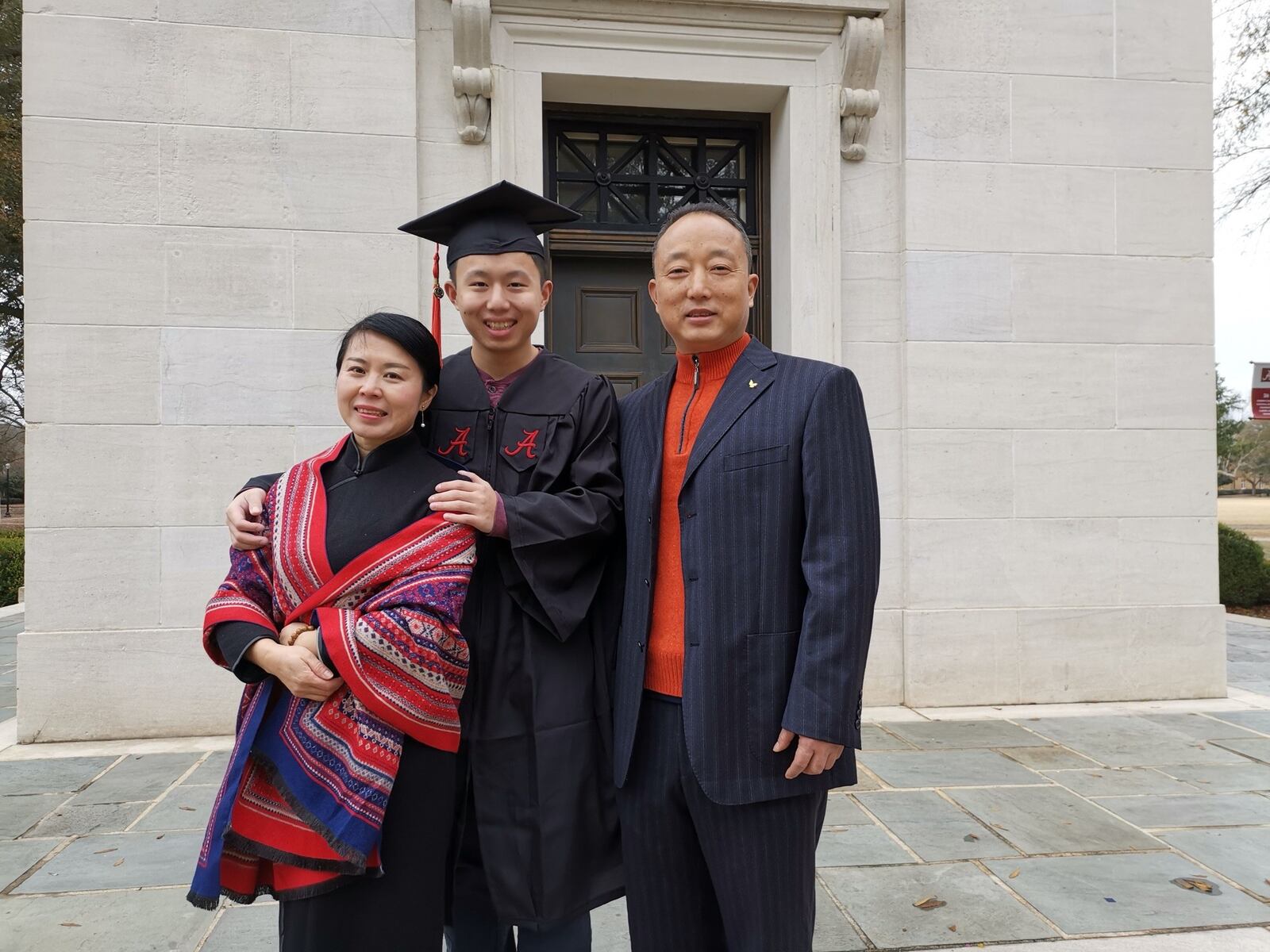 Hyde (QiYun) Li with his mother, XiaoPing, and his father, JianHua, at his graduation from the University of Alabama. CONTRIBUTED