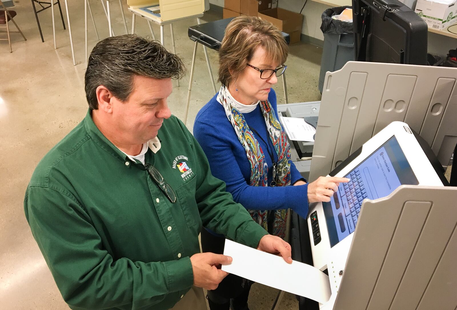 Montgomery County Board of Elections Director Jan Kelly and Deputy Director Steve Harsman give a presentation to county commissioners on the touch-screen hybrid voting system the elections board members recommend. CHRIS STEWART / STAFF