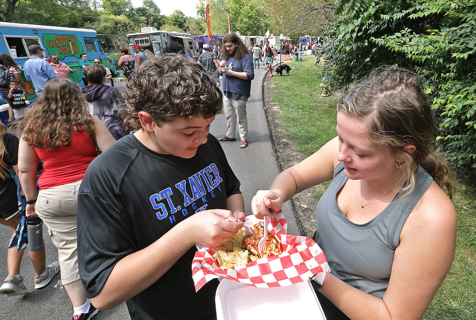 Grace Hehman and her brother Eric share a lobster roll Saturday at the Springfield Rotary Gourmet Food Truck Competition in Veteran's Park. BILL LACKEY/STAFF