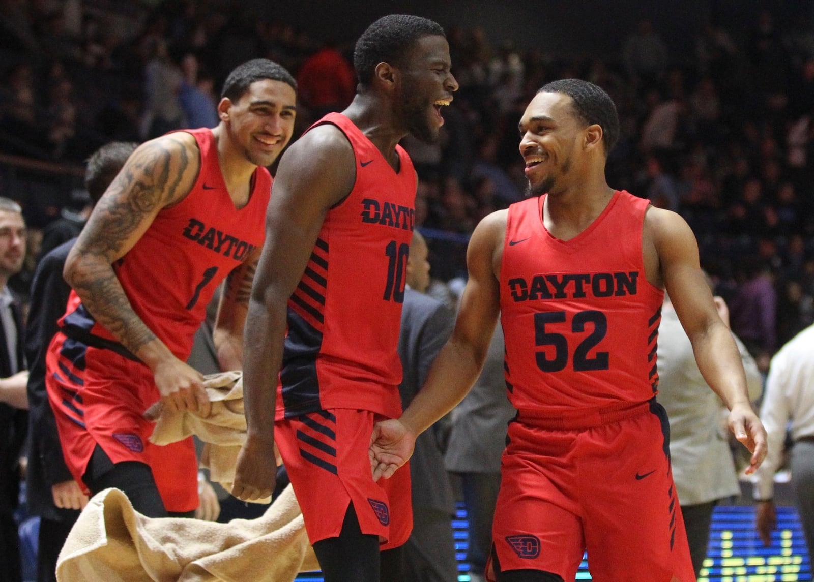 Dayton’s Jalen Crutcher, center, reacts after a 3-pointer by Camron Greer, right, against Rhode Island on Saturday, Feb. 9, 2019, at the Ryan Center in Kingston, R.I. David Jablonski/Staff