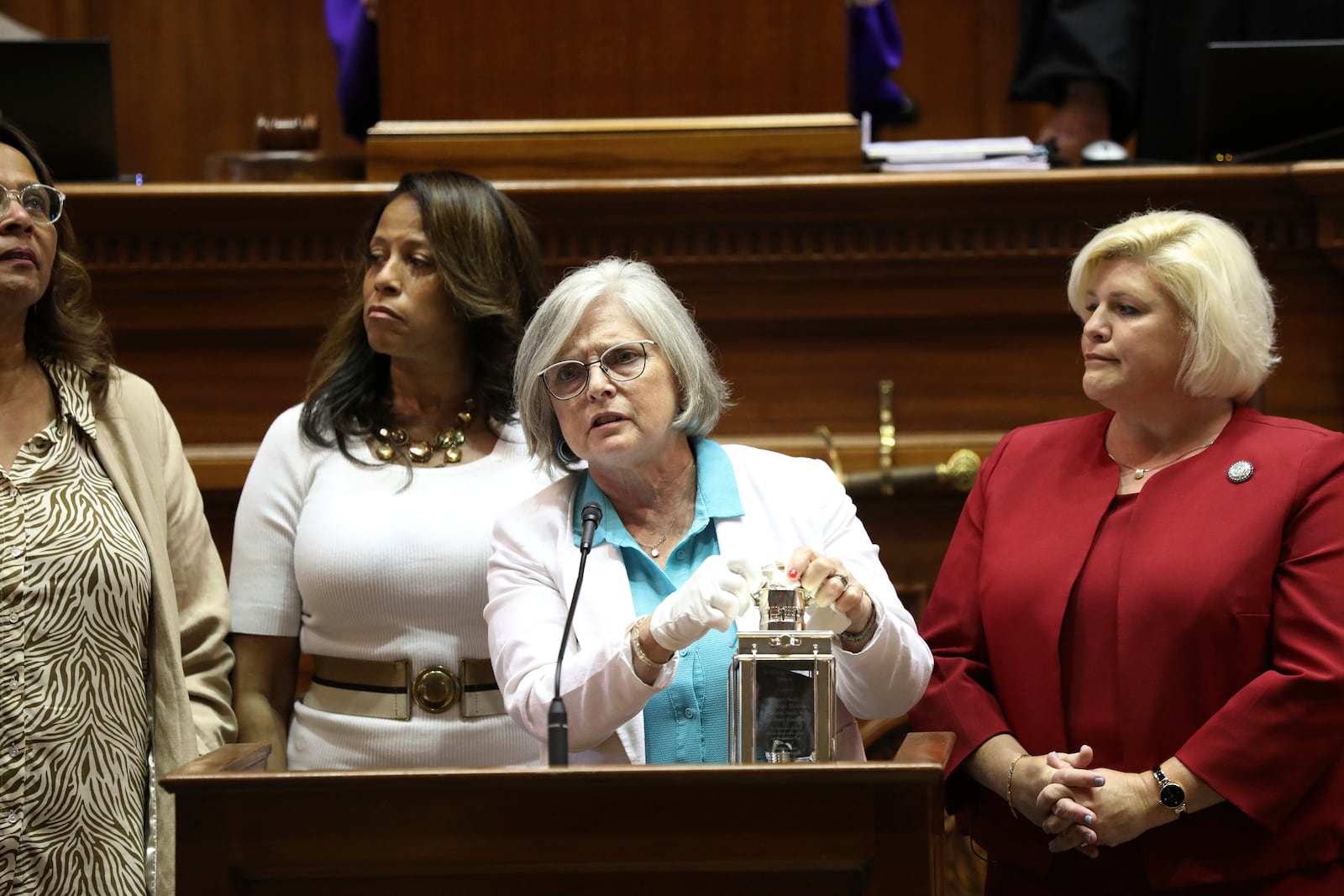 FILE - Four of South Carolina's Sister Senators, from left to right, Sen. Margie Bright Matthews, D-Walterboro, Sen. Mia McLeod, I-Columbia, Sen. Katrina Shealy, R-Lexington, and Sen. Penry Gustafson, R-Camden, stand in front of the Senate with their John F. Kennedy Profile in Courage award, June 26, 2024, in Columbia, S.C. (AP Photo/Jeffrey Collins, File)