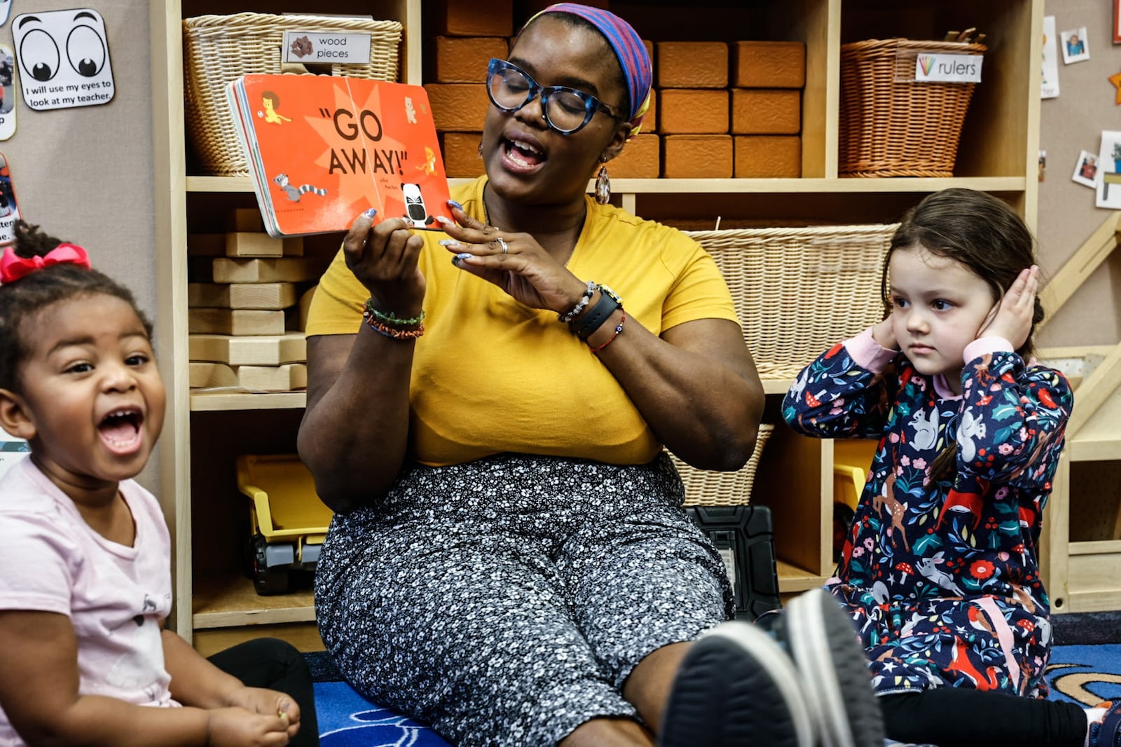 Mini University at Sinclair Community College PreK teacher, Lisa Adams reads a book to the children Wednesday April 5, 2023. JIM NOELKER/STAFF