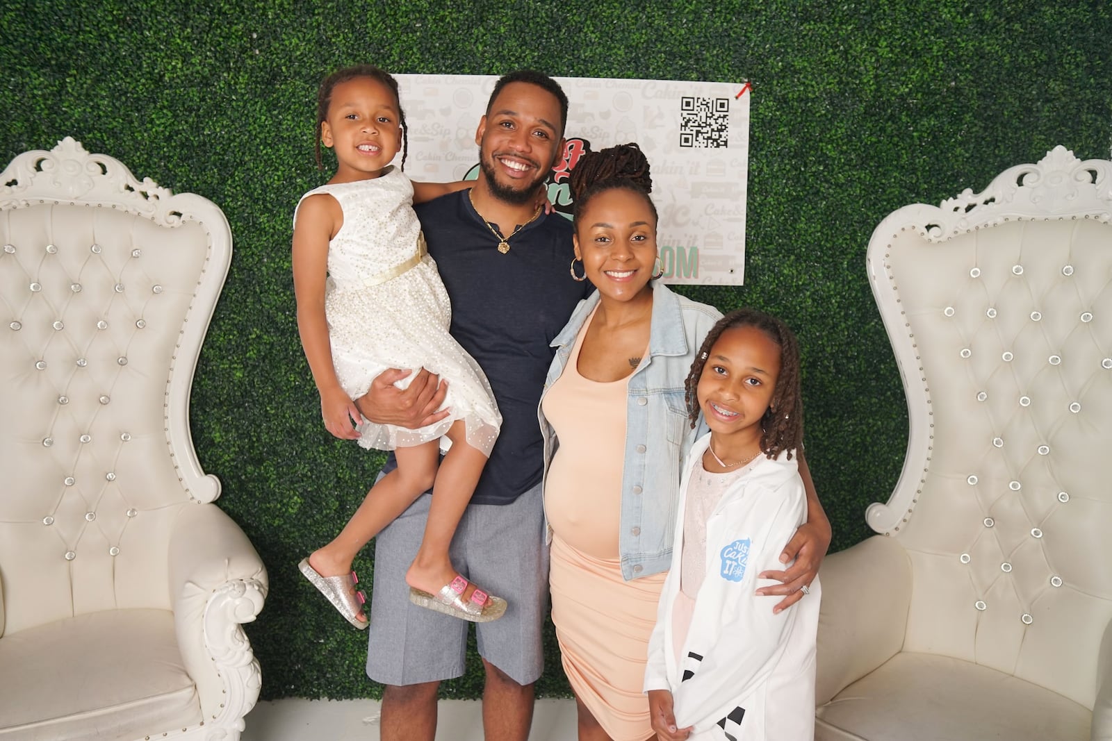 Courtney Barrett, the founder of Just Cakin' It, with her husband, Joshua, and daughters, Bailey (left) and Brooklyn (right).