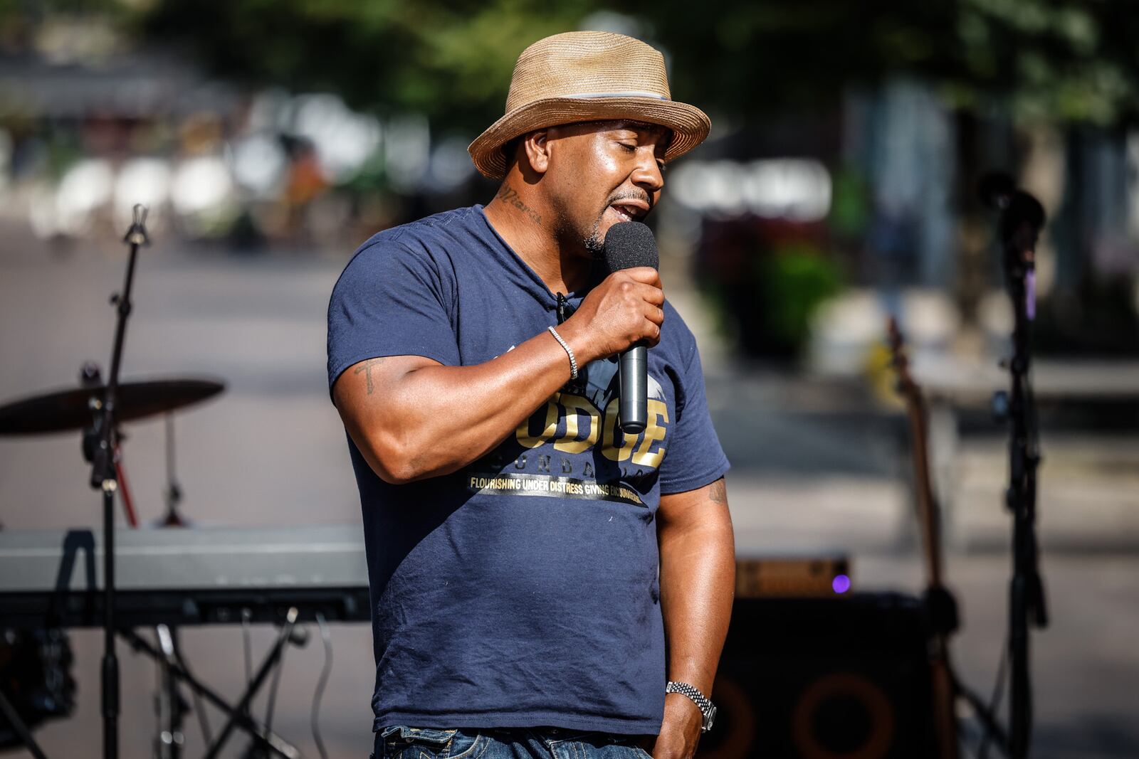 Oregon District mass shooting survivor Dion Green speaks to the crowd Friday, Aug. 4, 2023, on the four-year anniversary of the attack during a remembrance: "Never Forget the 9." The event was sponsored by the Fudge Foundation, founded by Green in honor of his father, Derrick Fudge, who died in his arms that night in Dayton. JIM NOELKER/STAFF