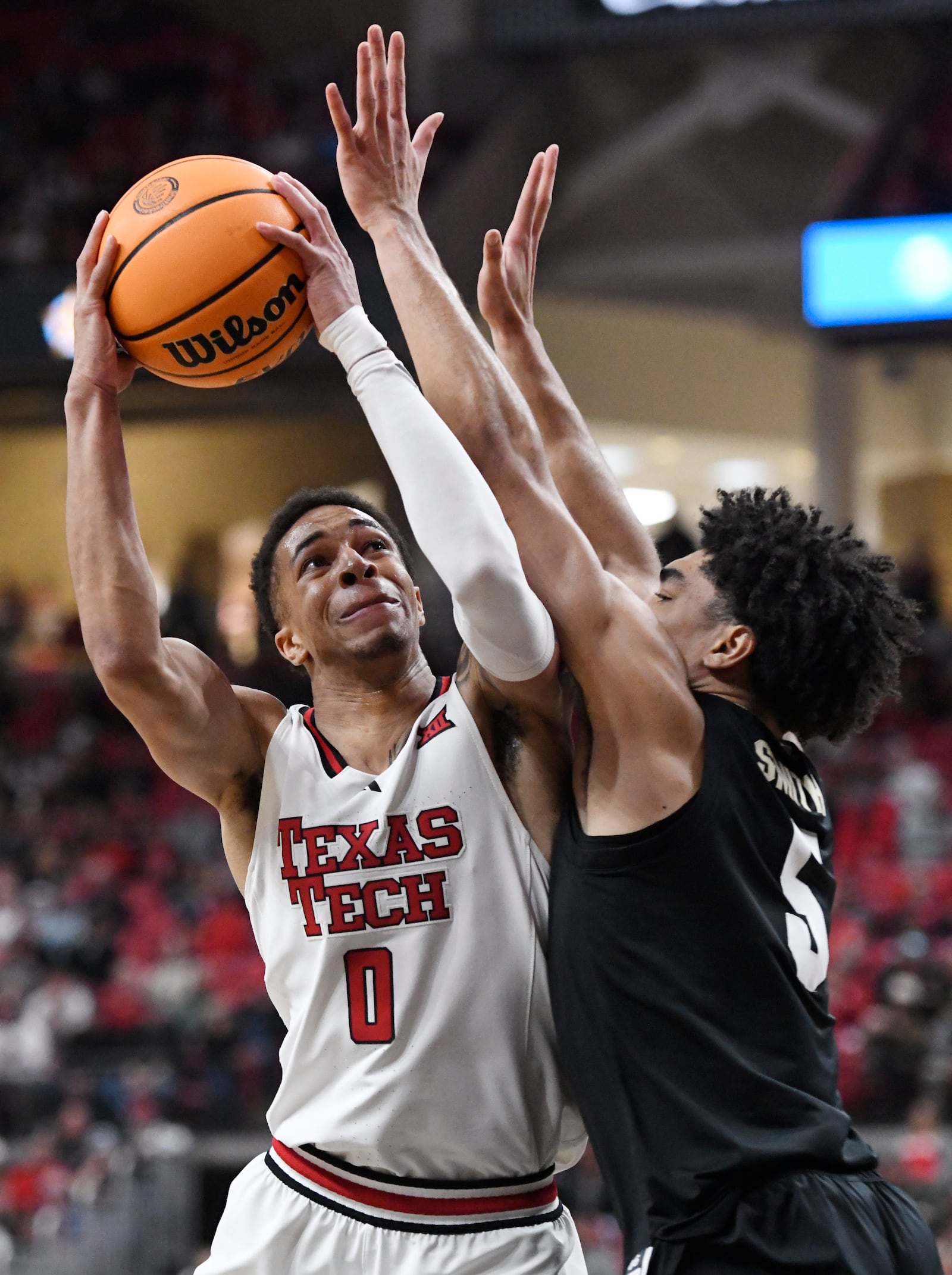 Texas Tech guard Chance McMillian (0) attempts to shoot the ball while Colorado guard RJ Smith (5) guards during the first half of an NCAA college basketball game, Wednesday, March 5, 2025, in Lubbock, Texas. (AP Photo/Annie Rice)