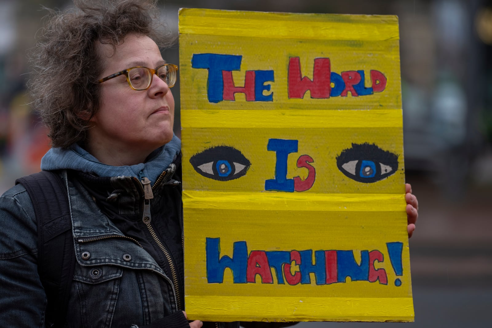 Activists protest outside the International Court of Justice, in The Hague, Netherlands, as it opens hearings into what countries worldwide are legally required to do to combat climate change and help vulnerable nations fight its devastating impact, Monday, Dec. 2, 2024. (AP Photo/Peter Dejong)