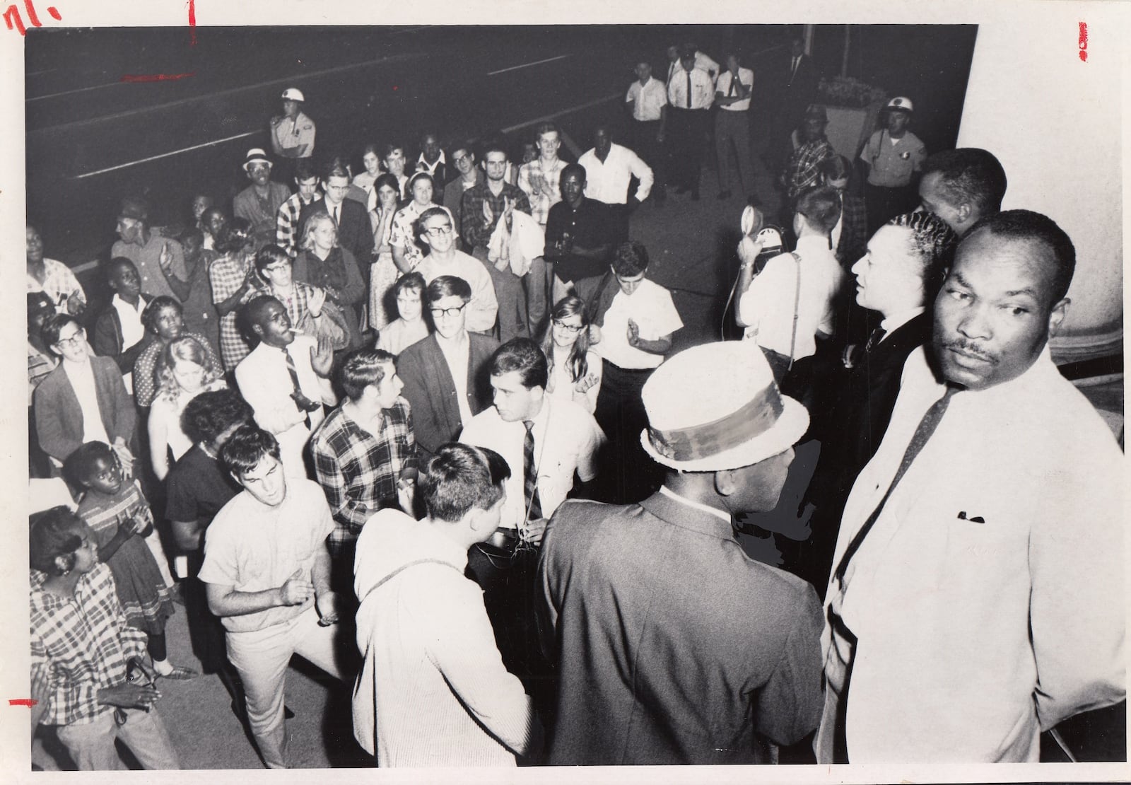 Photo dated Aug. 5, 1965 and captioned "Sumpter McIntosh (right) gathers  people (about 50) in front of the Municipal Building at Third and Ludlow streets after a commission meeting was over." DAYTON DAILY NEWS / WRIGHT STATE UNIVERSITY COLLECTION AND ARCHIVES 
