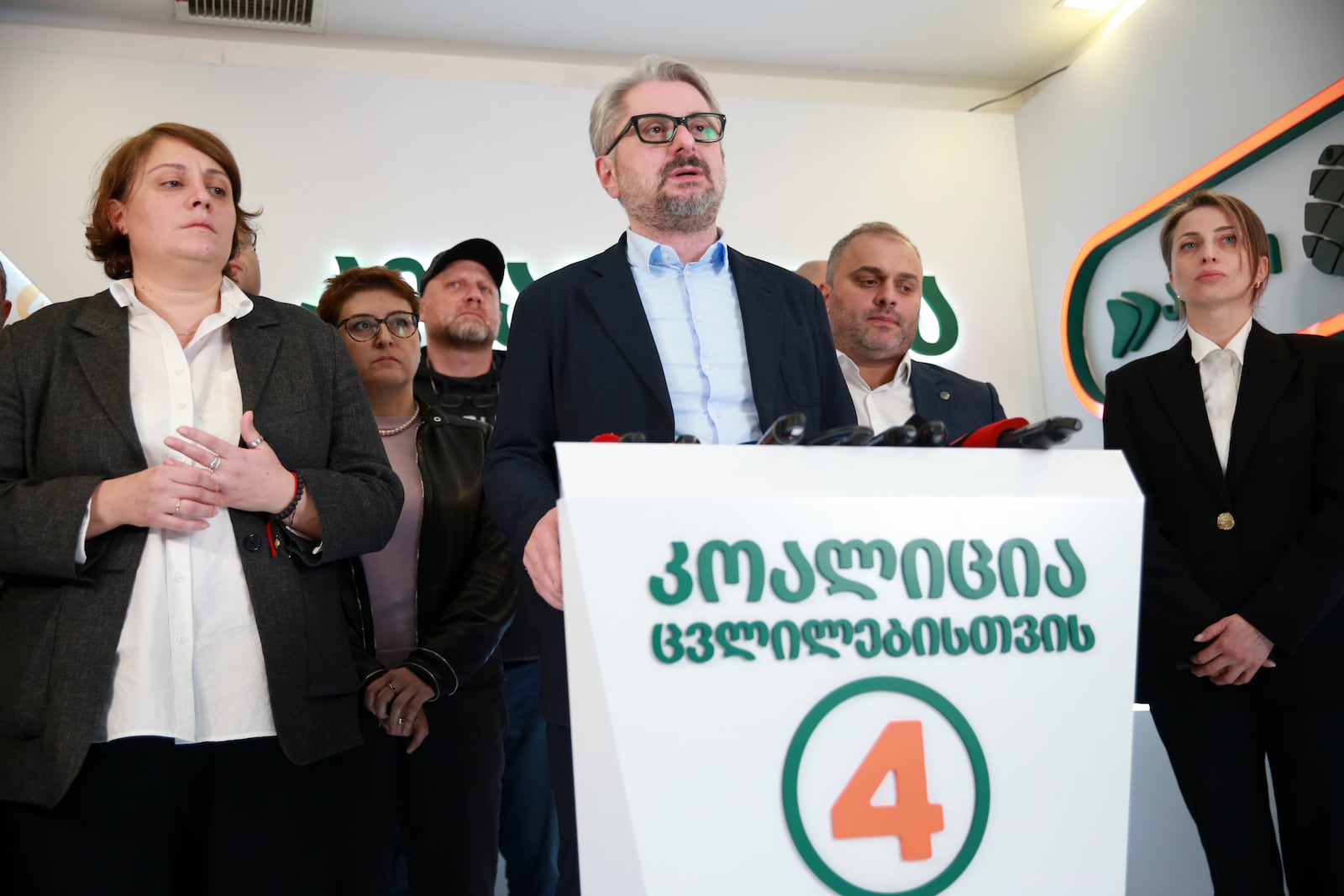 Nika Gvaramia, leader of Coalition for Changes, center, speaks to the media as Elene Khoshtaria, chair of United National Movement, left, and Nana Malashkhia, who leads the Coalition for Change parliament list, right, stand near at coalition's headquarters after the parliamentary election in Tbilisi, Georgia, early Sunday, Oct. 27, 2024. (AP Photo/Zurab Tsertsvadze)