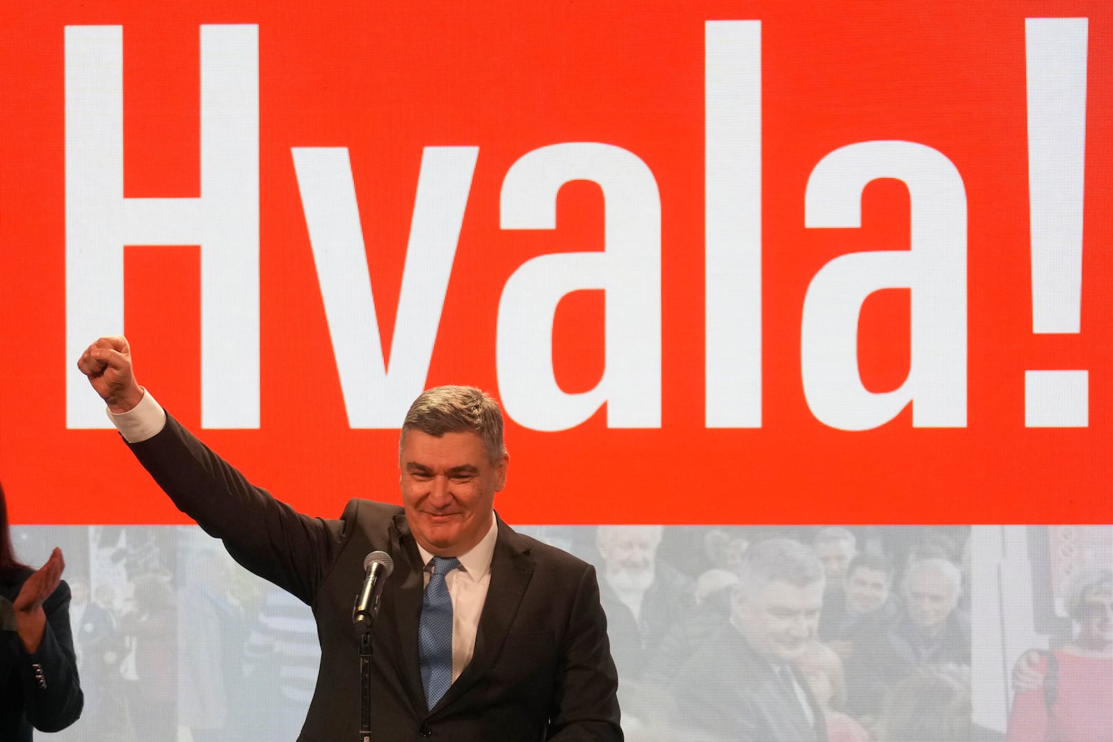 President incumbent Zoran Milanovic greets his supporters as the preliminary results grant him victory in a runoff vote for the Croatian presidential election in Zagreb, Croatia, Sunday, Jan. 12, 2025. The sign reads "Thank You". (AP Photo/Darko Bandic)